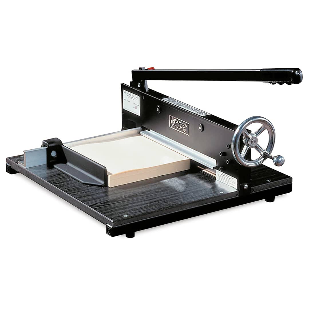 Open in modal - Commercial Stack Cutter - Angled view with blade slightly raised and clamp holding paper stack