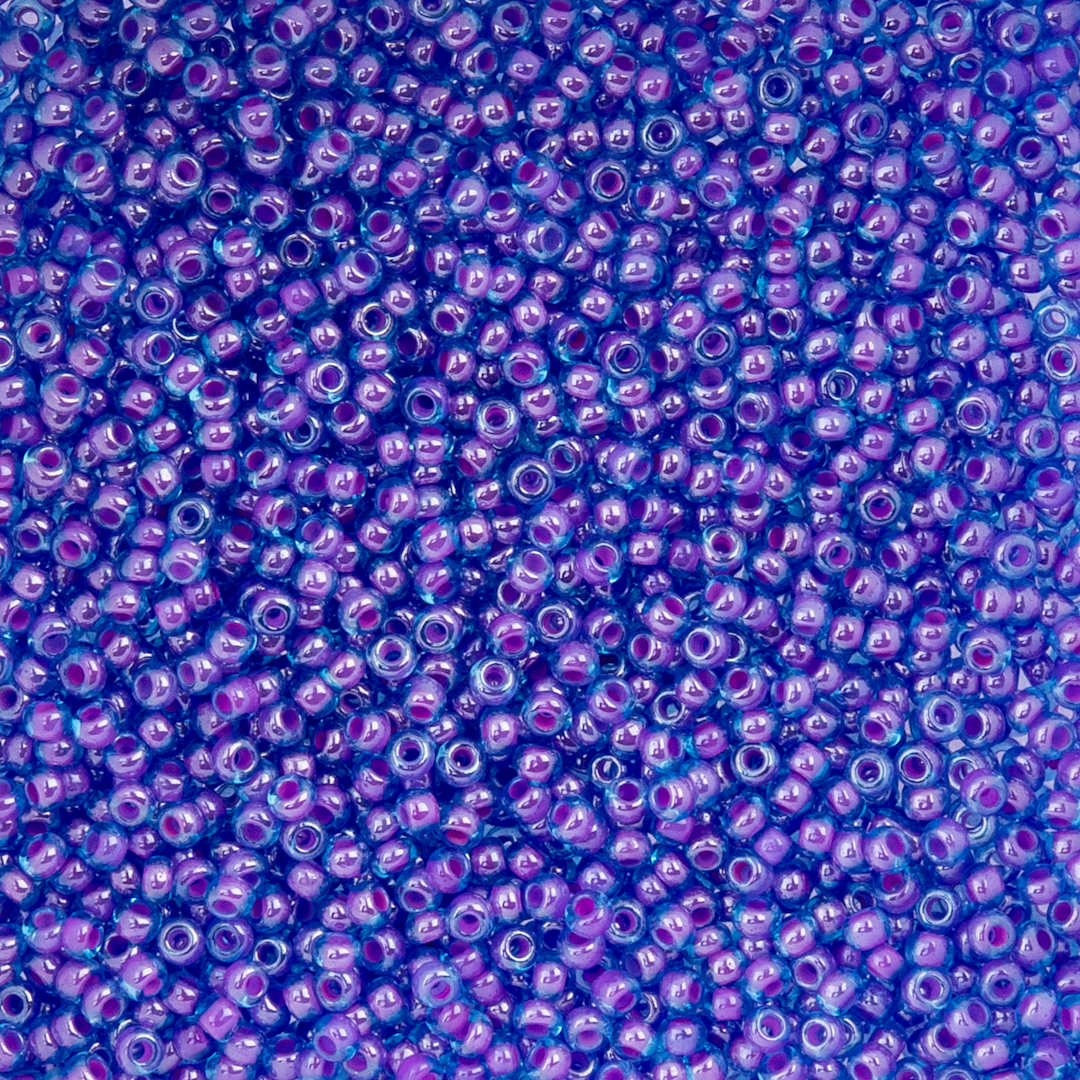 Open in modal - John Bead Czech Glass Seed Beads - Color-Lined Fuchsia and Transparent Blue, 10/0, 22 g Vial close up