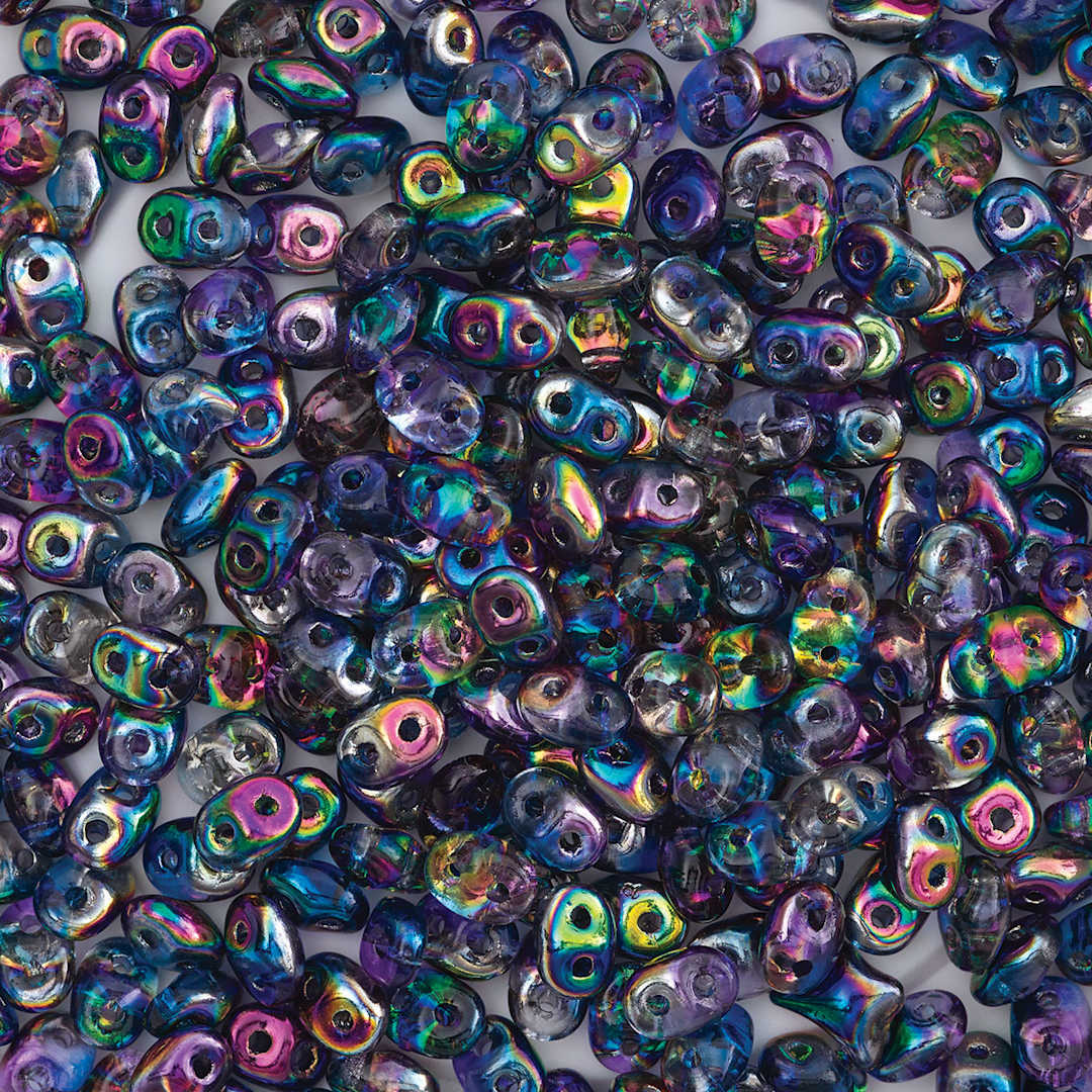 Open in modal - John Bead Czech Glass SuperDuo Two-Hole Beads - Pile of Blue/Pink Metallic beads shown