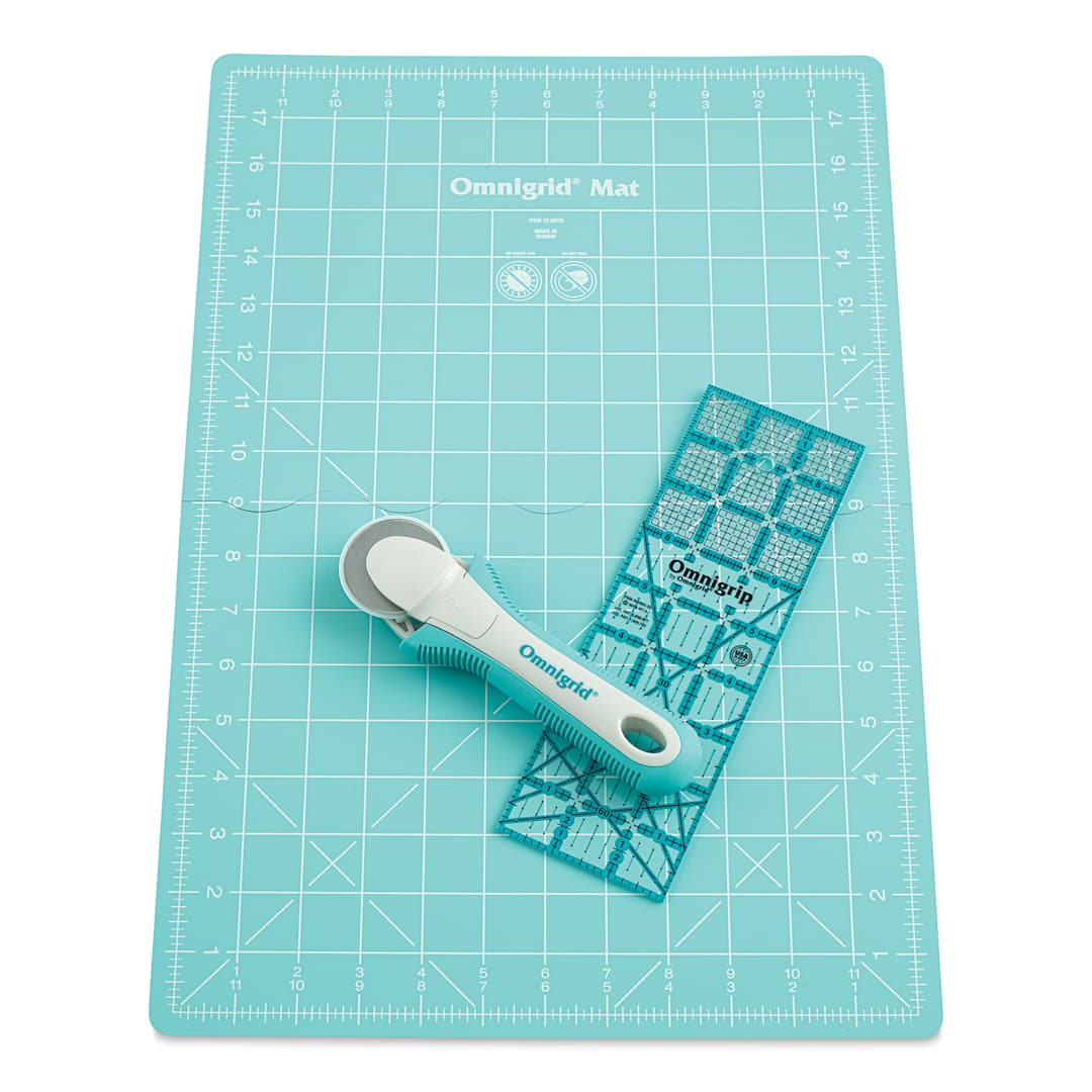 Open in modal - Rotary cutter with small unfolded mat and ruler laid out