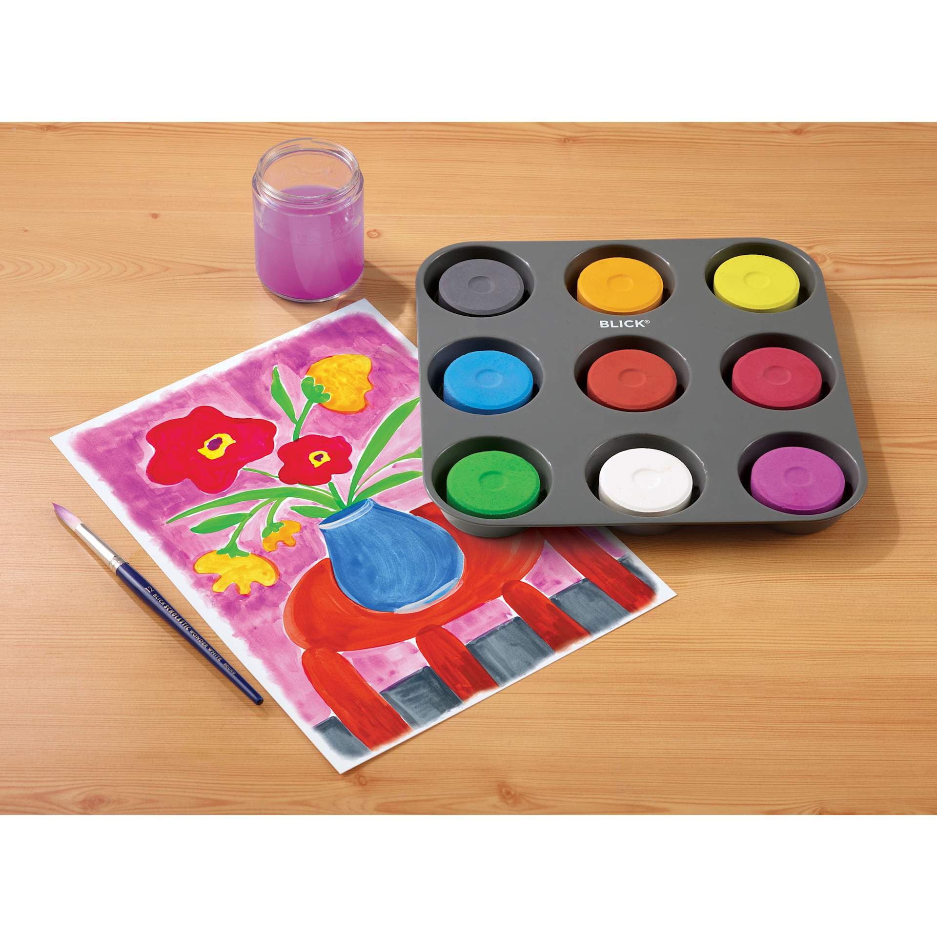 Blick Essentials Tempera Cakes Set of 9 Secondary Colors in a Tray with a brush, cup of water, and a painting of flowers.
