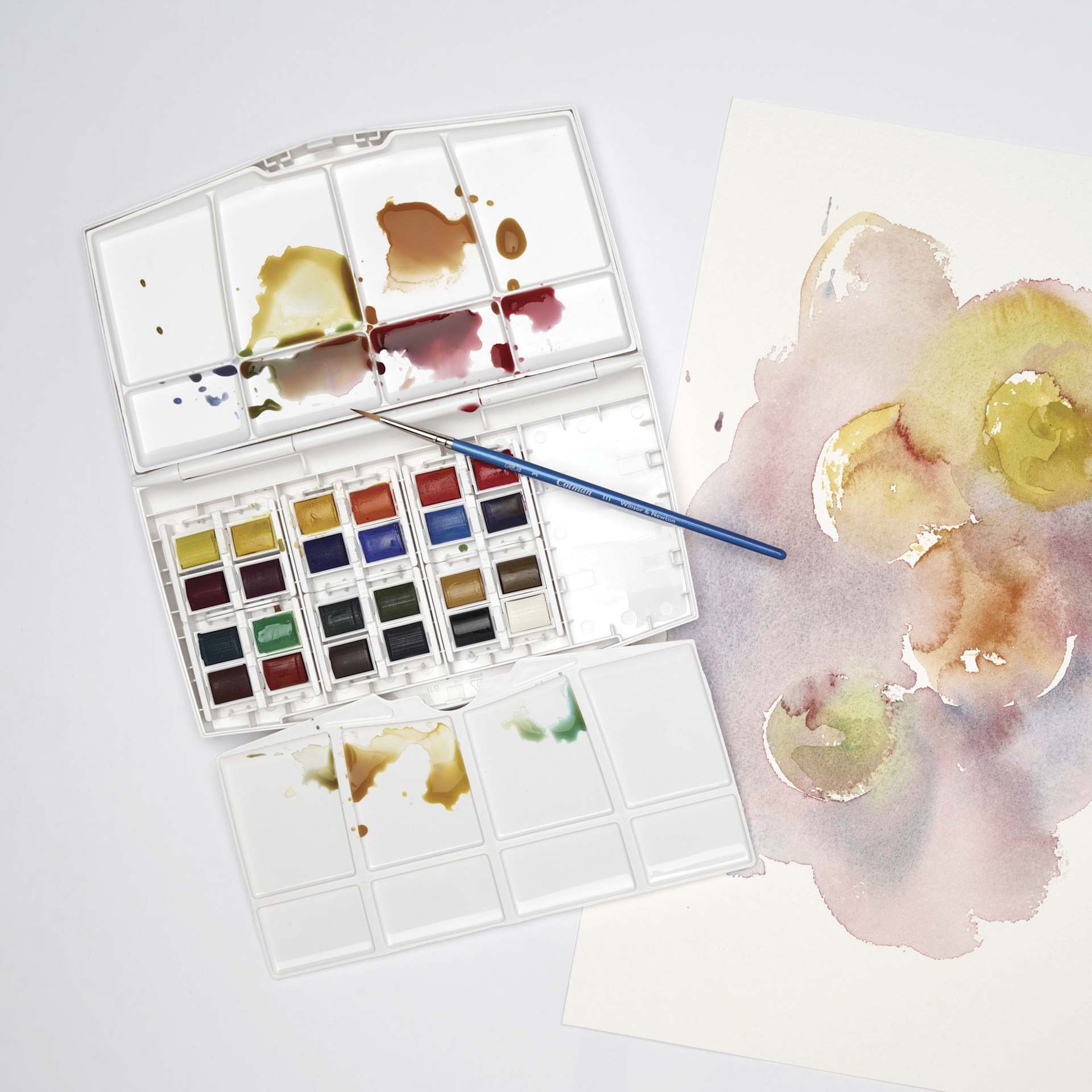 Winsor & Newton Cotman Watercolors - Travel Set of 24, Assorted Colors, Half Pans, on desk