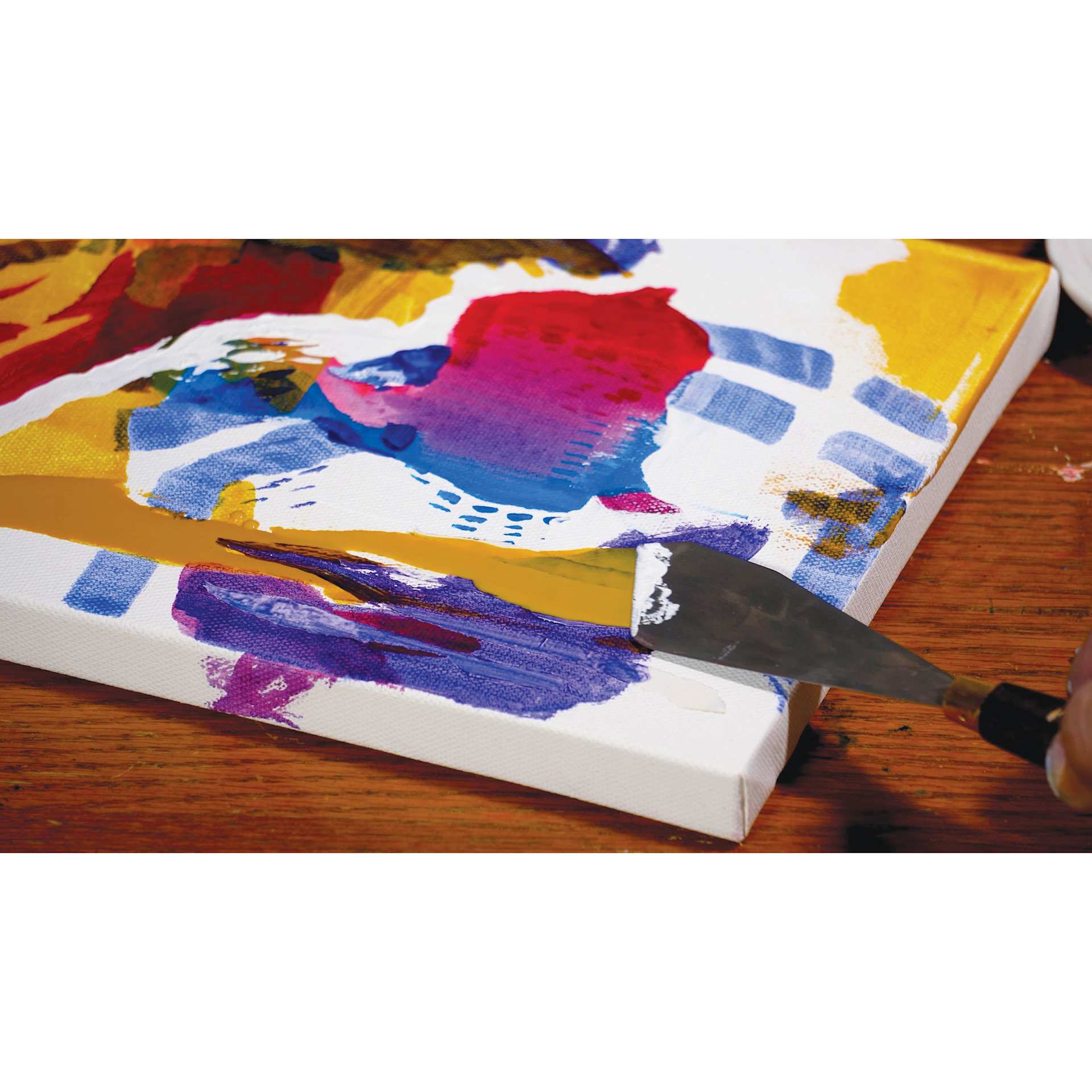 Liquitex Professional Soft Body Acrylic Paints and Sets, painting knife applying yellow paint on canvas