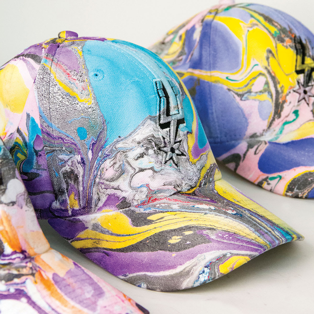 Jacquard Marbling Colors and Kits - Finished Marbled baseball caps shown
