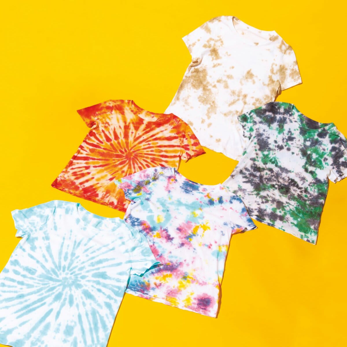 Rit Dye Powder - Top view of 4 tie-dyed t-shirts