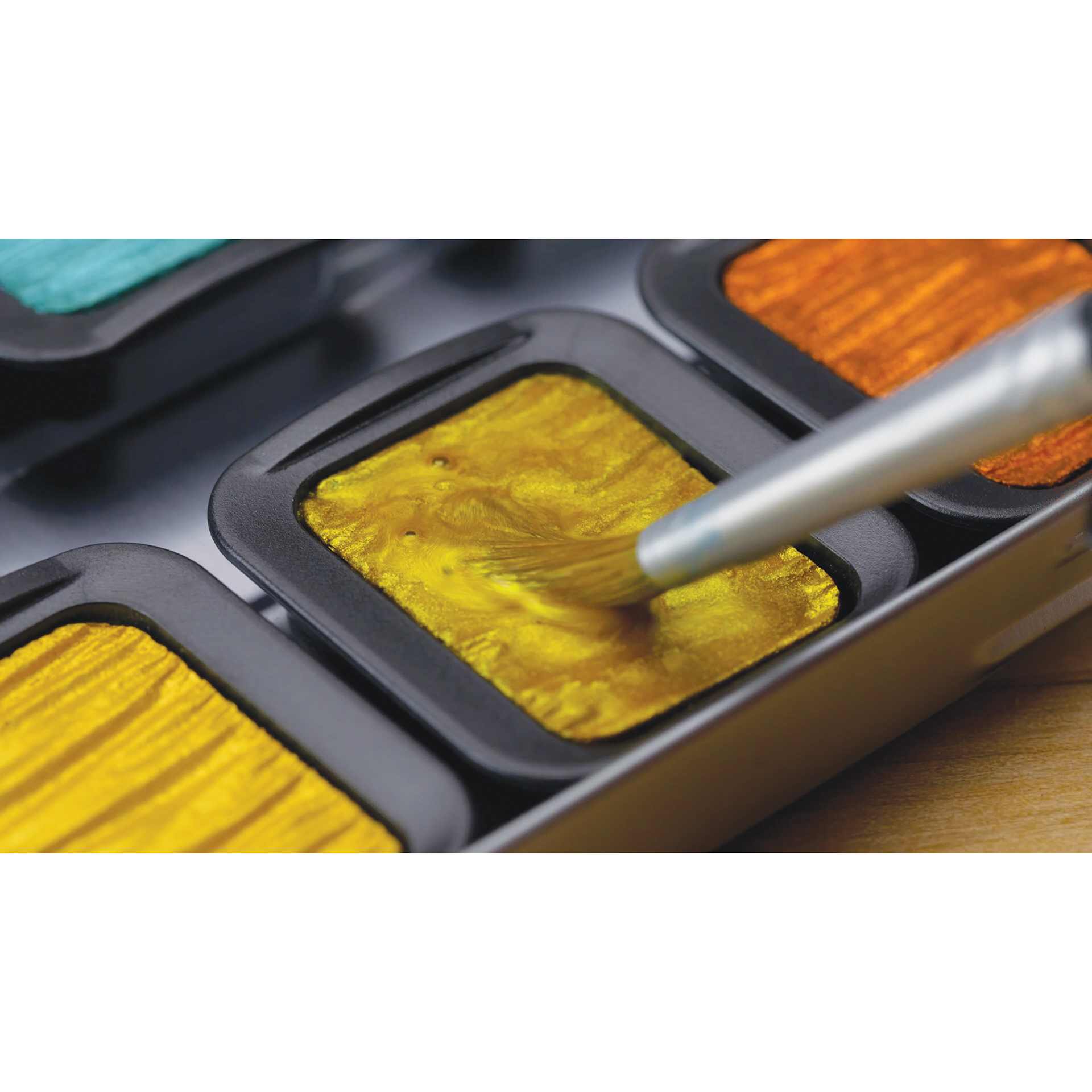 Finetec Artist Mica Watercolor Pans, close-up of paint being loaded onto brush