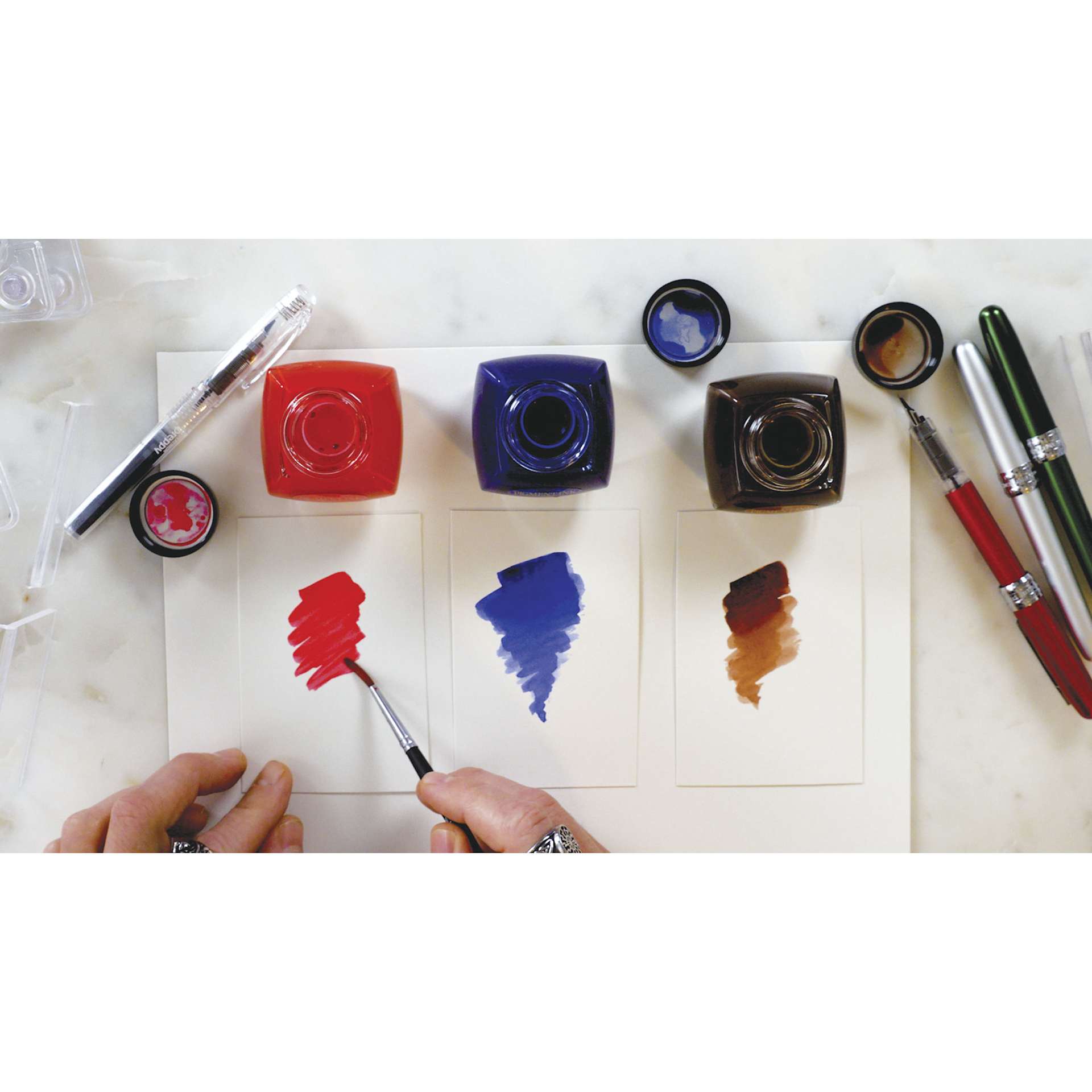 Platinum Pigment Inks, brush in hand creating swatches