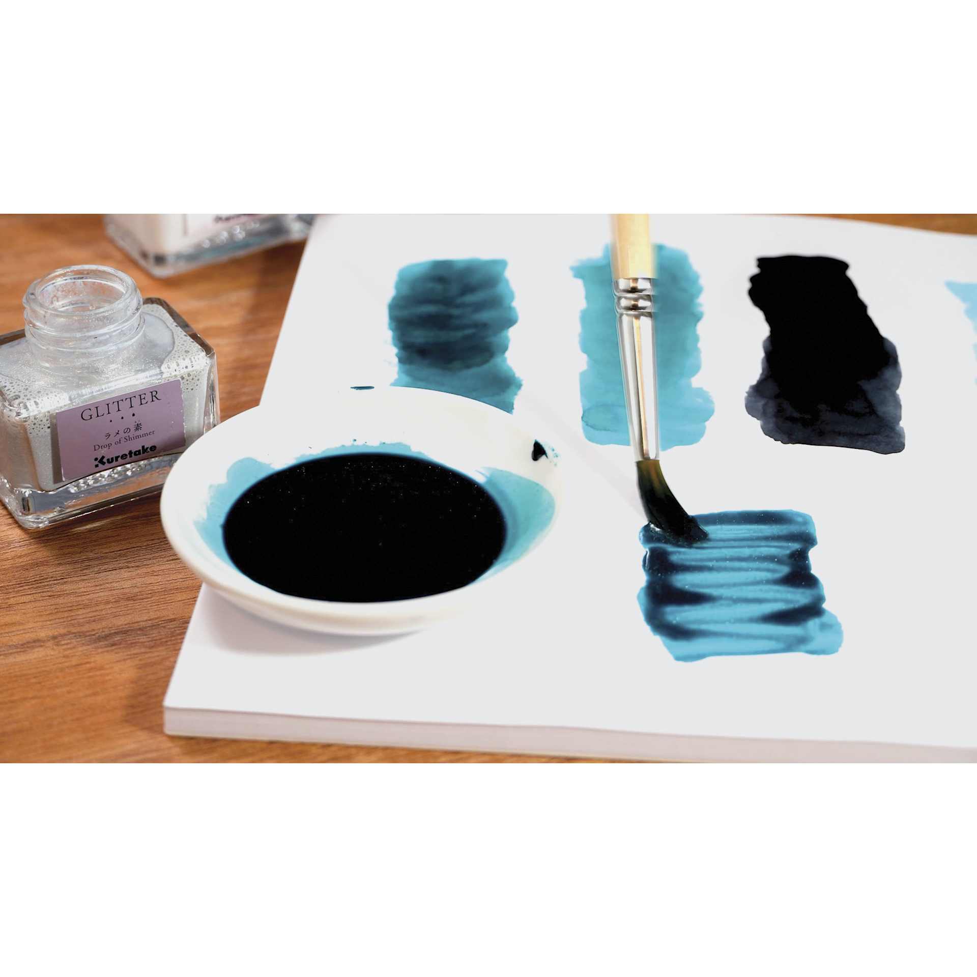 Kuretake Ink-Café Drop of Shimmer Ink Additive - Glitter, 20 ml, additive being brushed onto panel