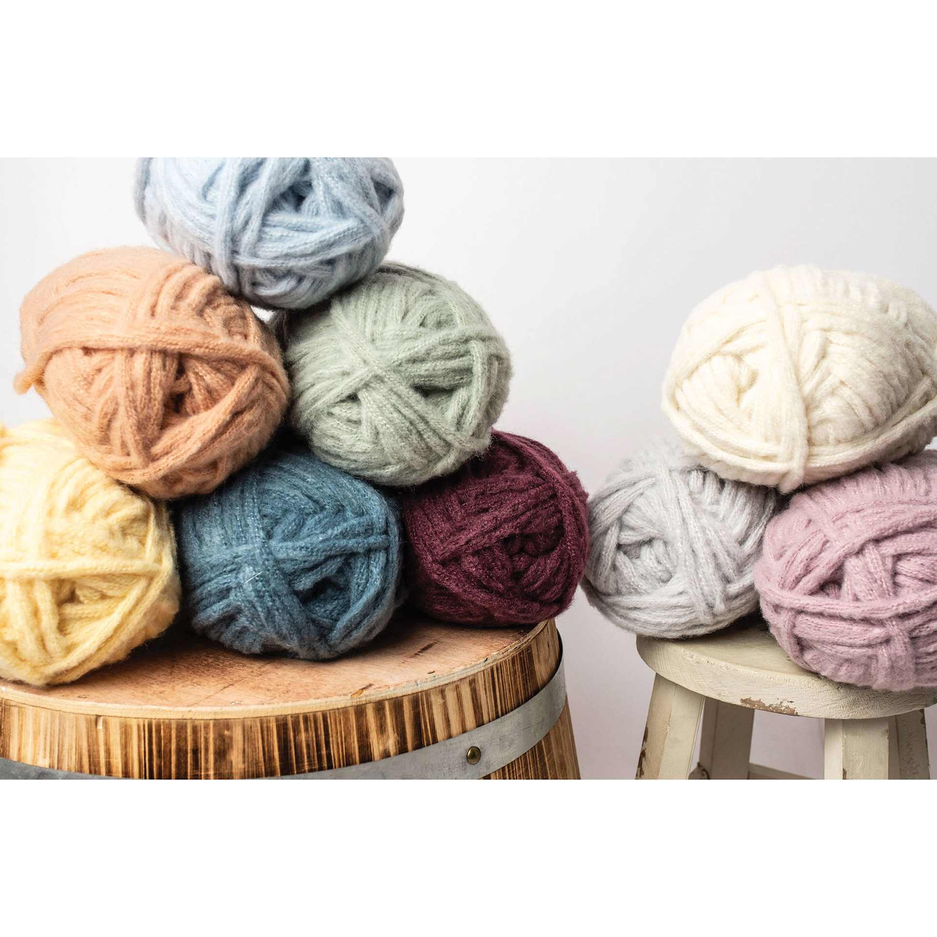 Lion Brand Feels Like Butta Thick & Quick Yarn, skeins on to of each other