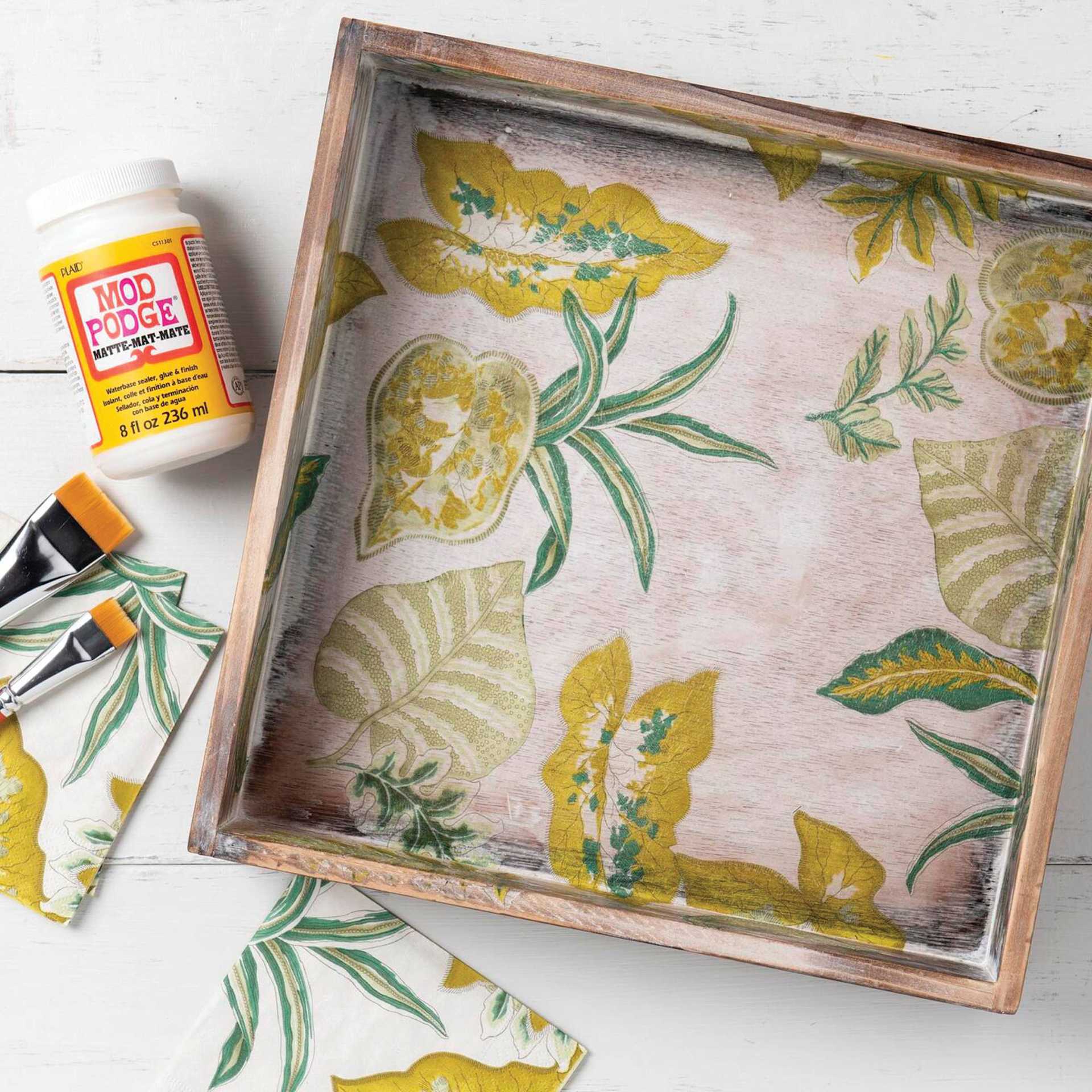 Plaid Mod Podge - Jar and brushes next to painted interior of a box sealed with Matte Finish