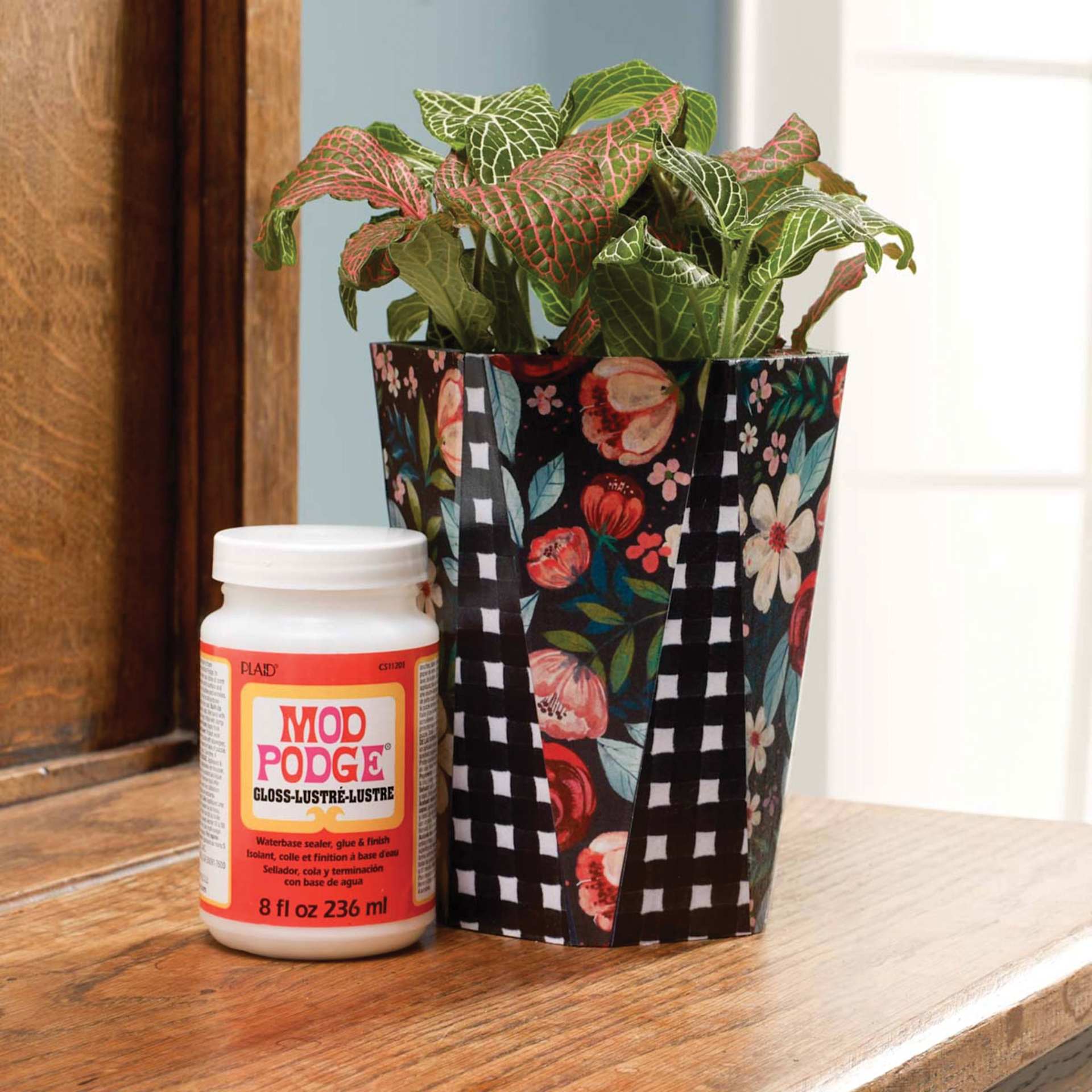 Floral pattern paper adhered to plant pot and sealed with Plaid Mod Podge Gloss Finish