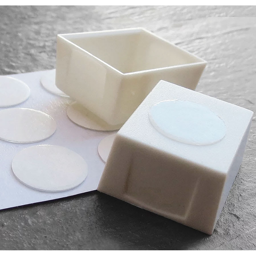 Half pan with adhesive dot to help keep it in place.
