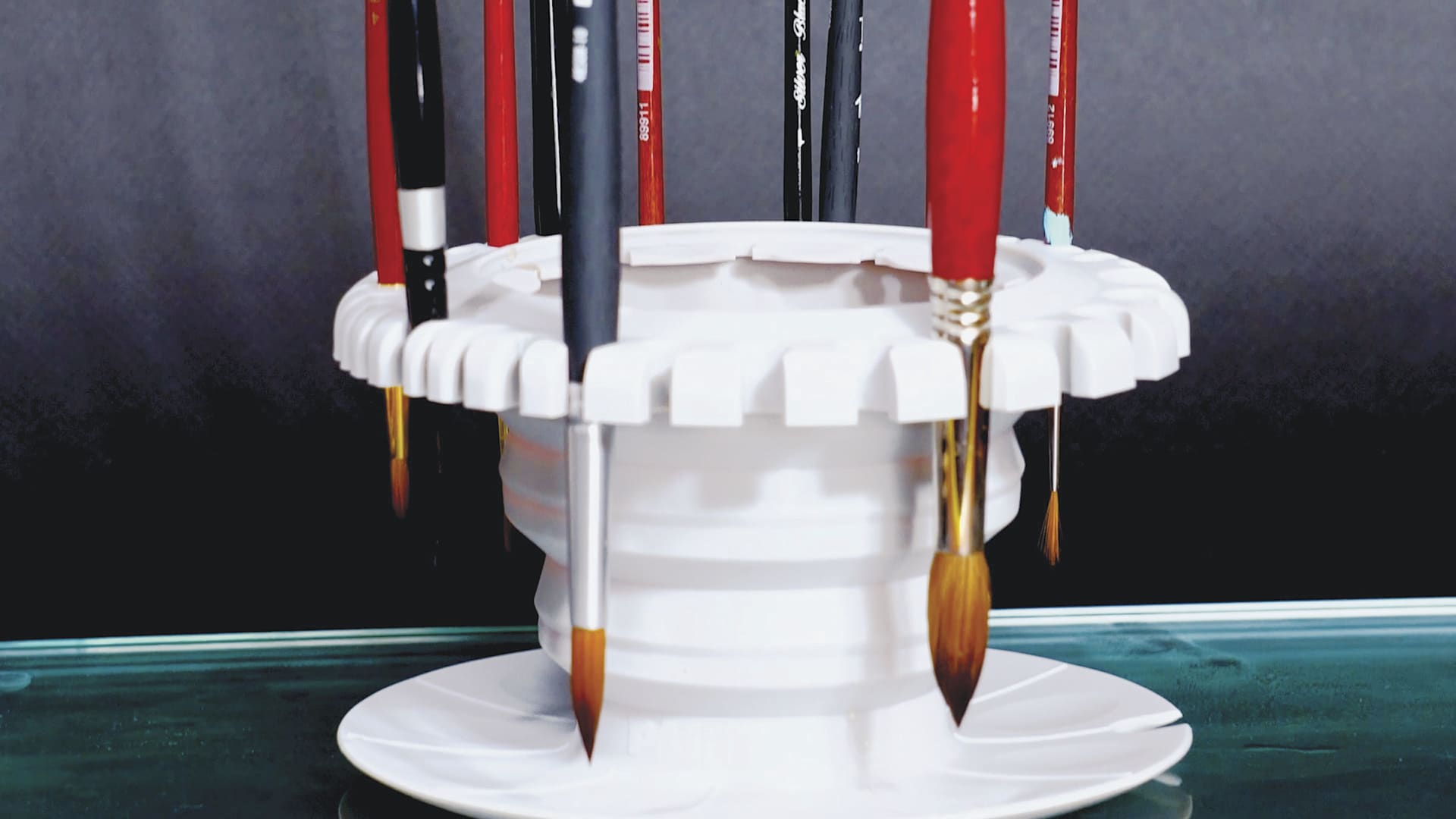 Paint Puck CollapsiBowl Portable Brush Cleaner, holding brushes, close-up