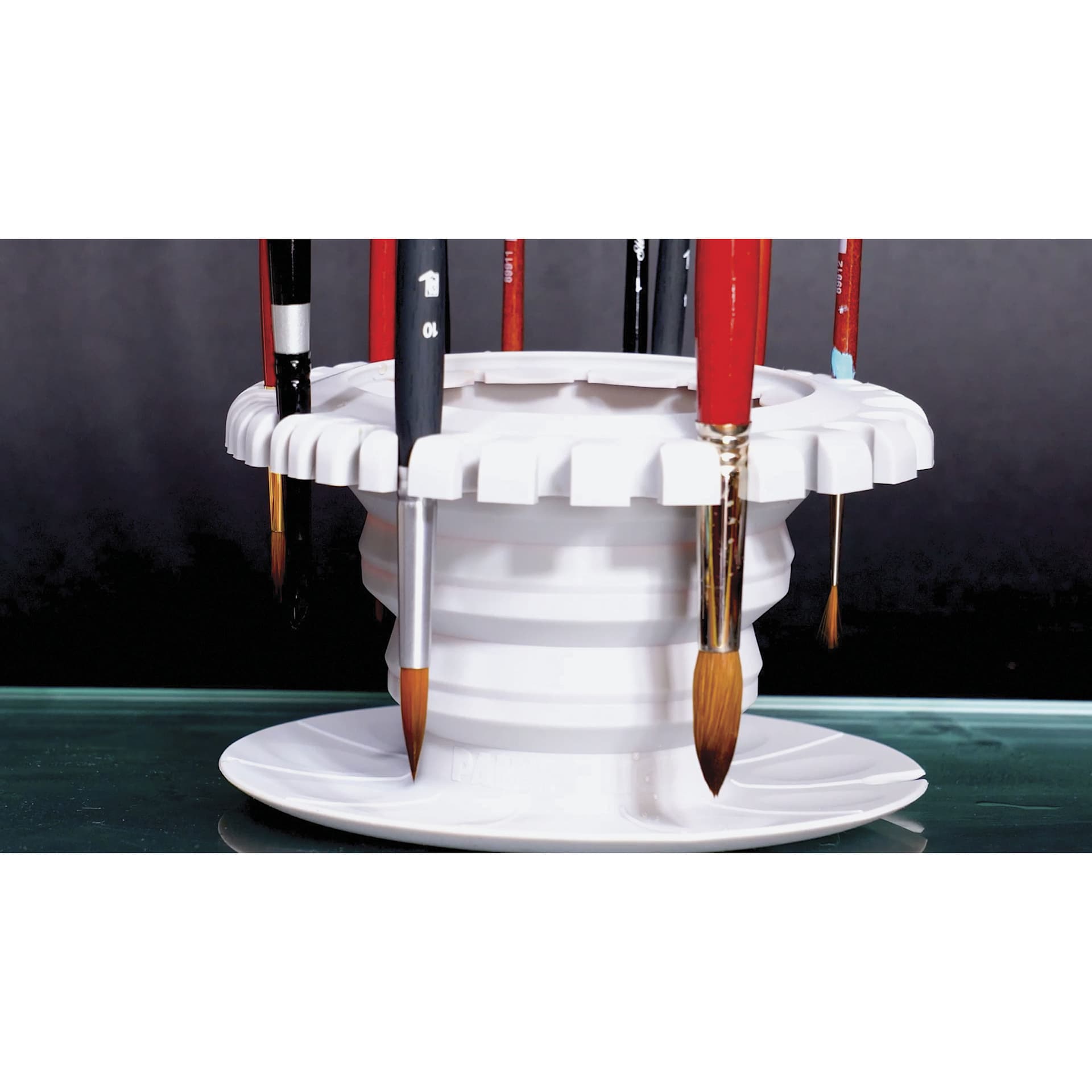 Paint Puck CollapsiBowl Portable Brush Cleaner, holding brushes