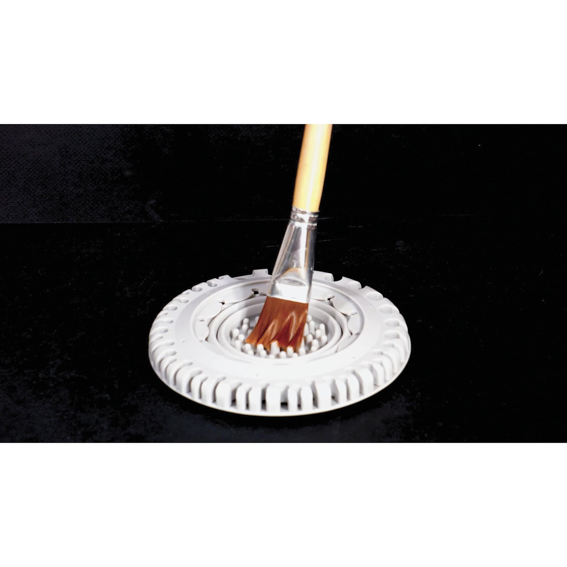 Paint Puck CollapsiBowl Portable Brush Cleaner, collapsed with brush being cleaned