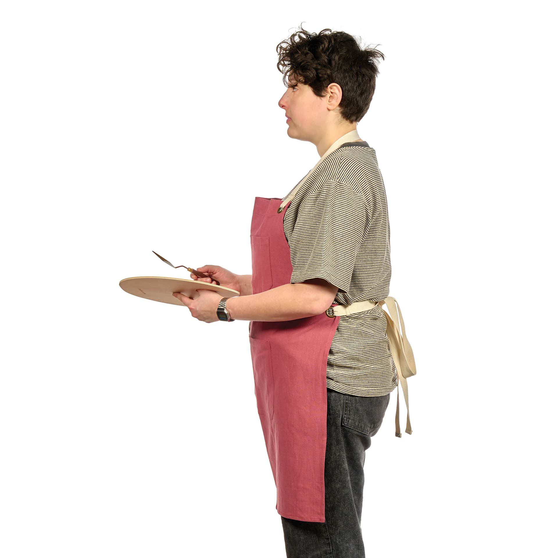 Side view of Blick Artisan Apron - Brick Red on a person