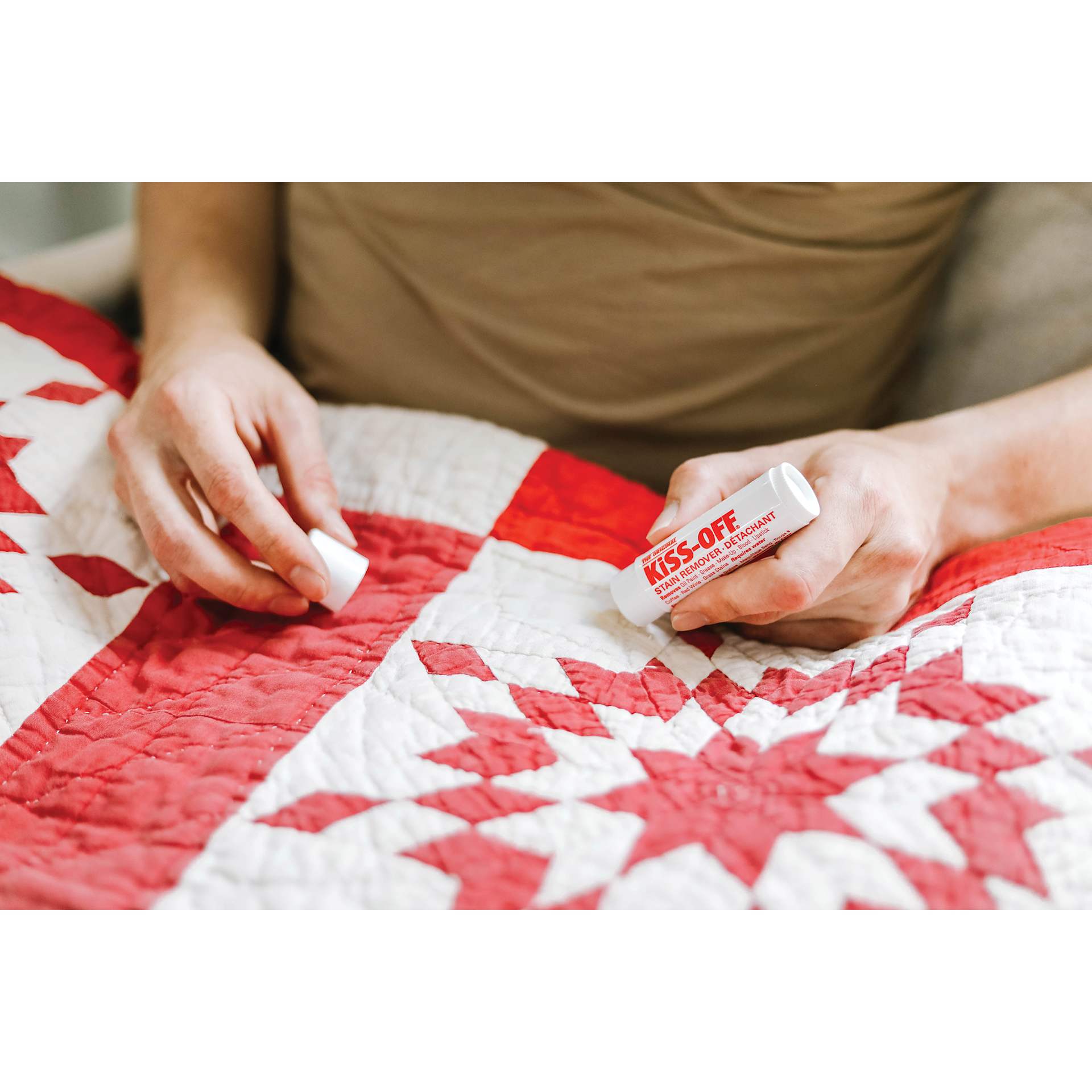 Kiss-Off Stain Remover, in hand removing stain from quilt