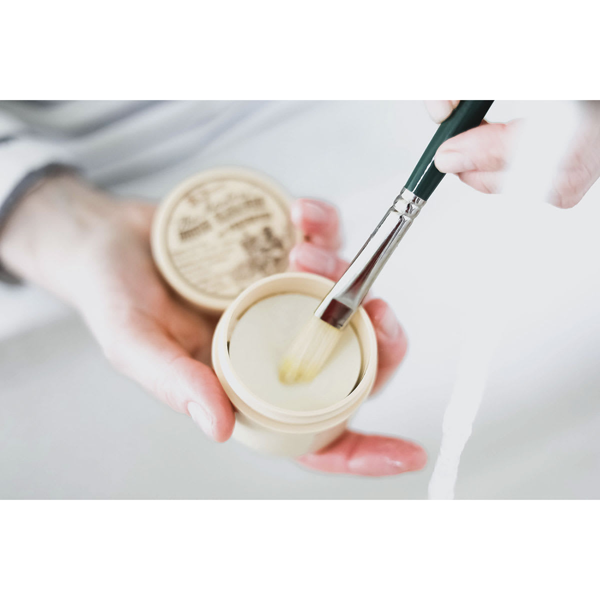 The Masters Brush Cleaner and Preserver-Studio Cake, 2-5/8 oz. Held open, brush bristles on cake.