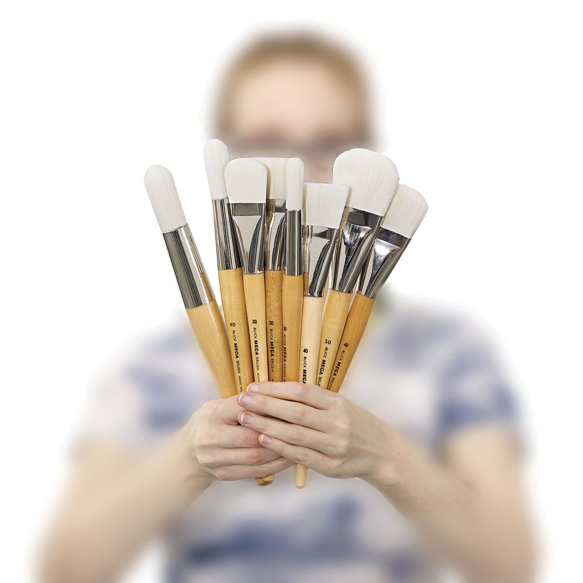 Blick Mega White Synthetic Brushes - woman holding assorted types of brushes available