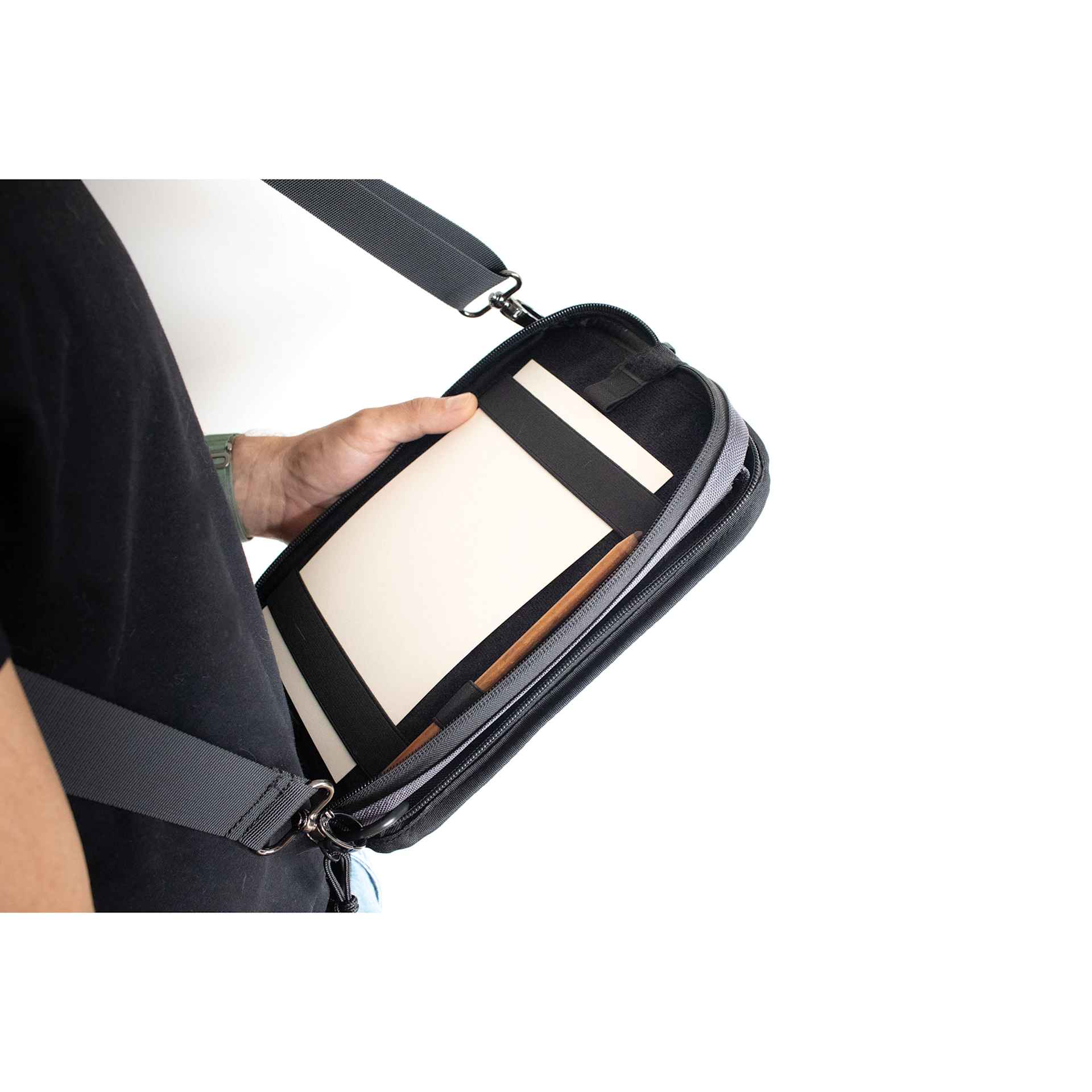 Etchr Nano Satchel - Grey, showing interior of the Satchel while strapped on and leaning on waist