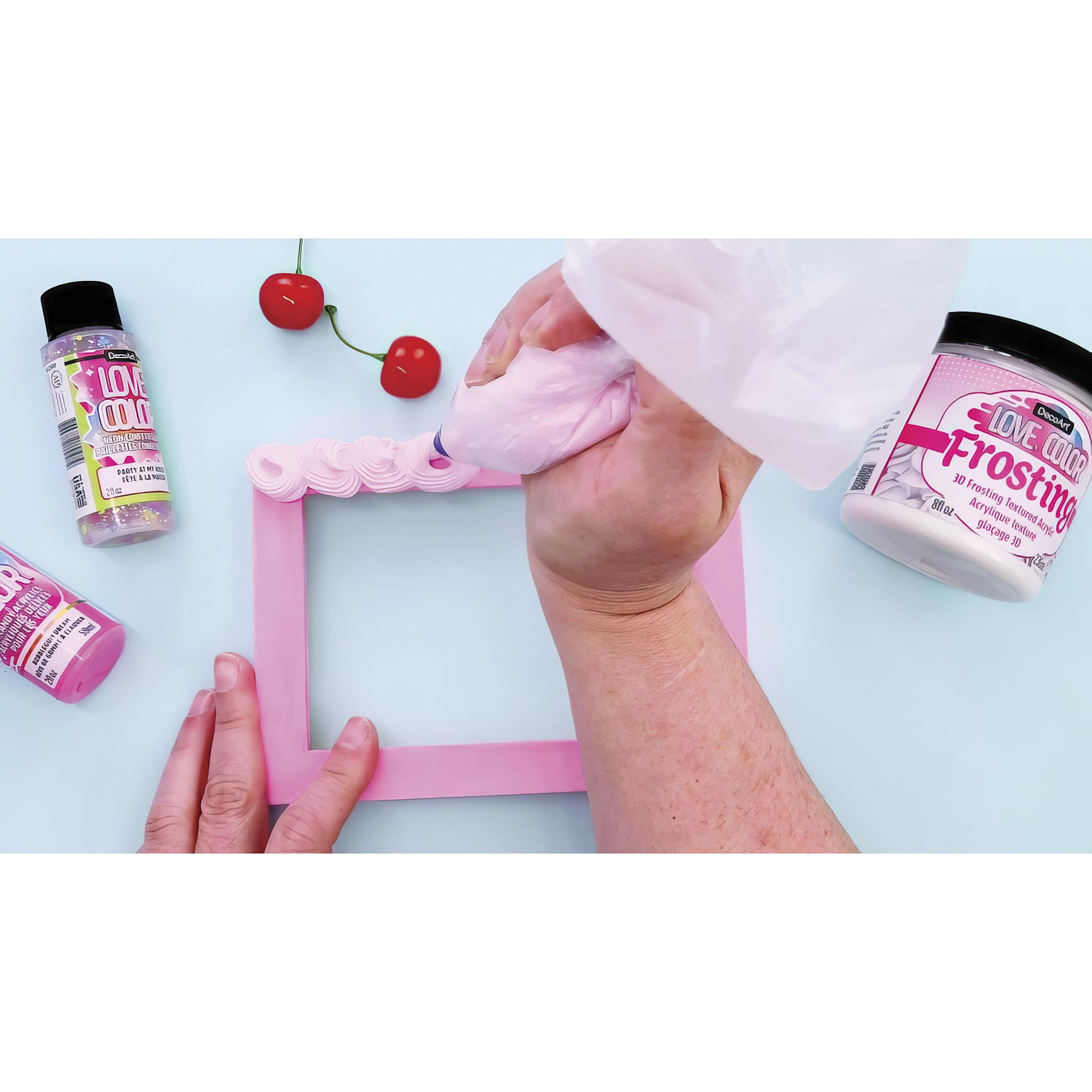 DecoArt Love Color Frosting Acrylic being used with an icing bag and frosting tip.