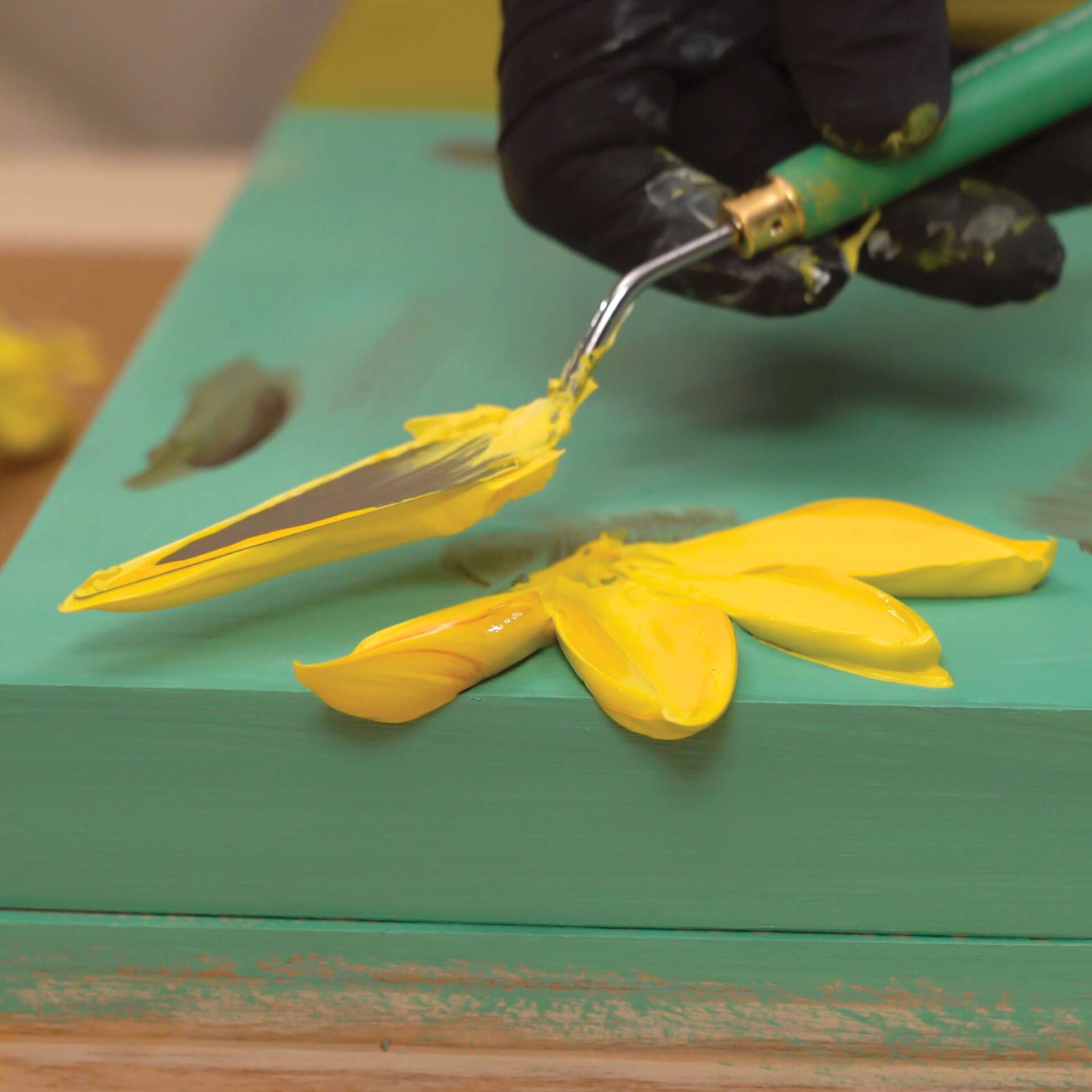 Gaffrey Heavy Body Texture Acrylic Paint - Cadmium Yellow Deep Hue, 32 oz being applied with a palette knife