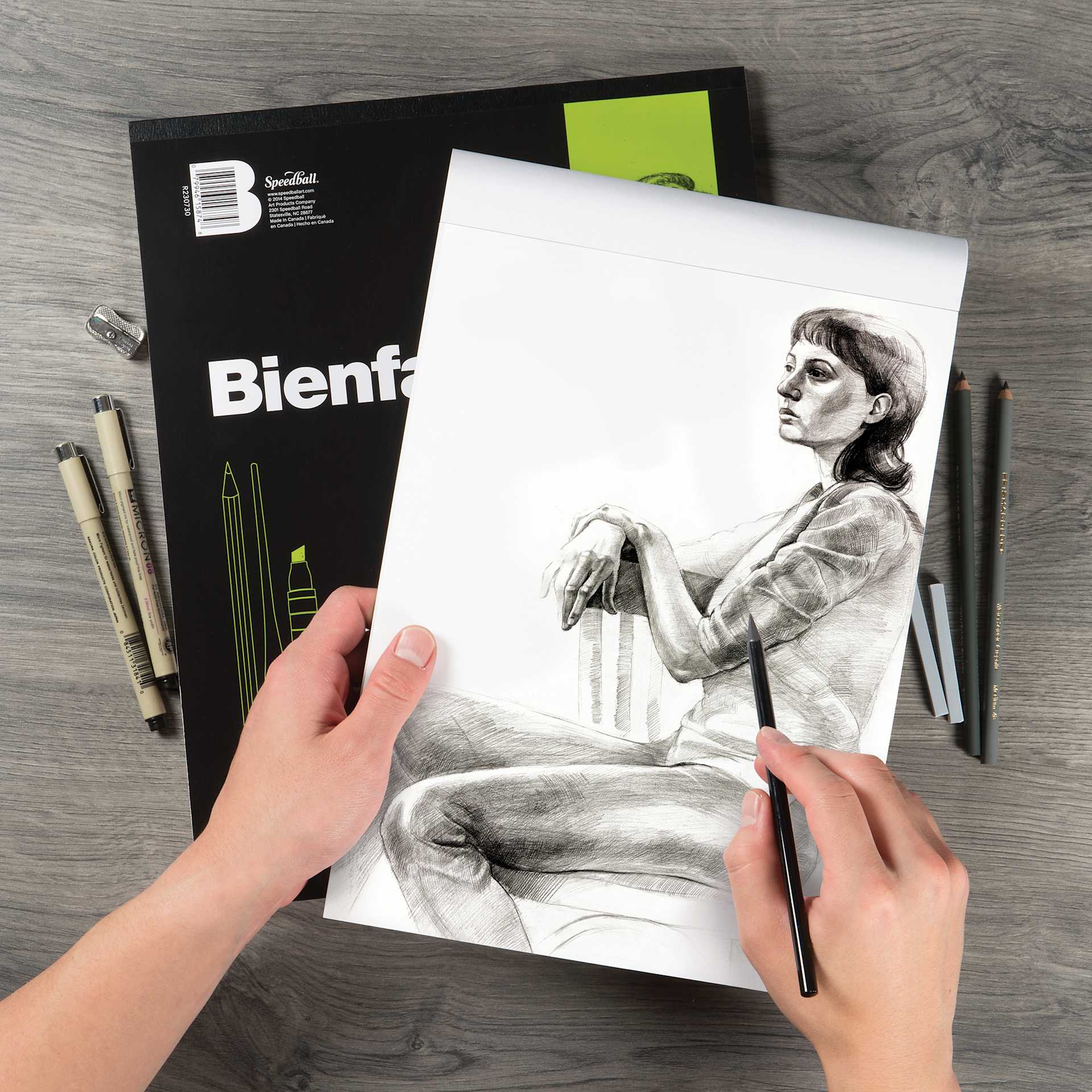 Bienfang Drawing Paper Pad, artist drawing on a sheet of paper with pencils (not included)