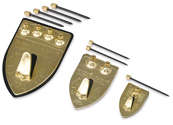 Ook Repositioning Shield Hangers - Different sizes shown in row with nails
