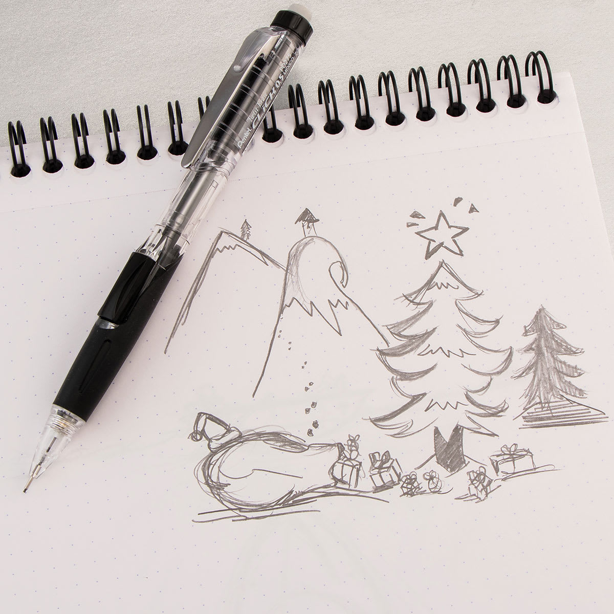 Pentel Twist-Erase Click Mechanical Pencil - 0.5 mm, Black laying a a sketchbook with drawing
