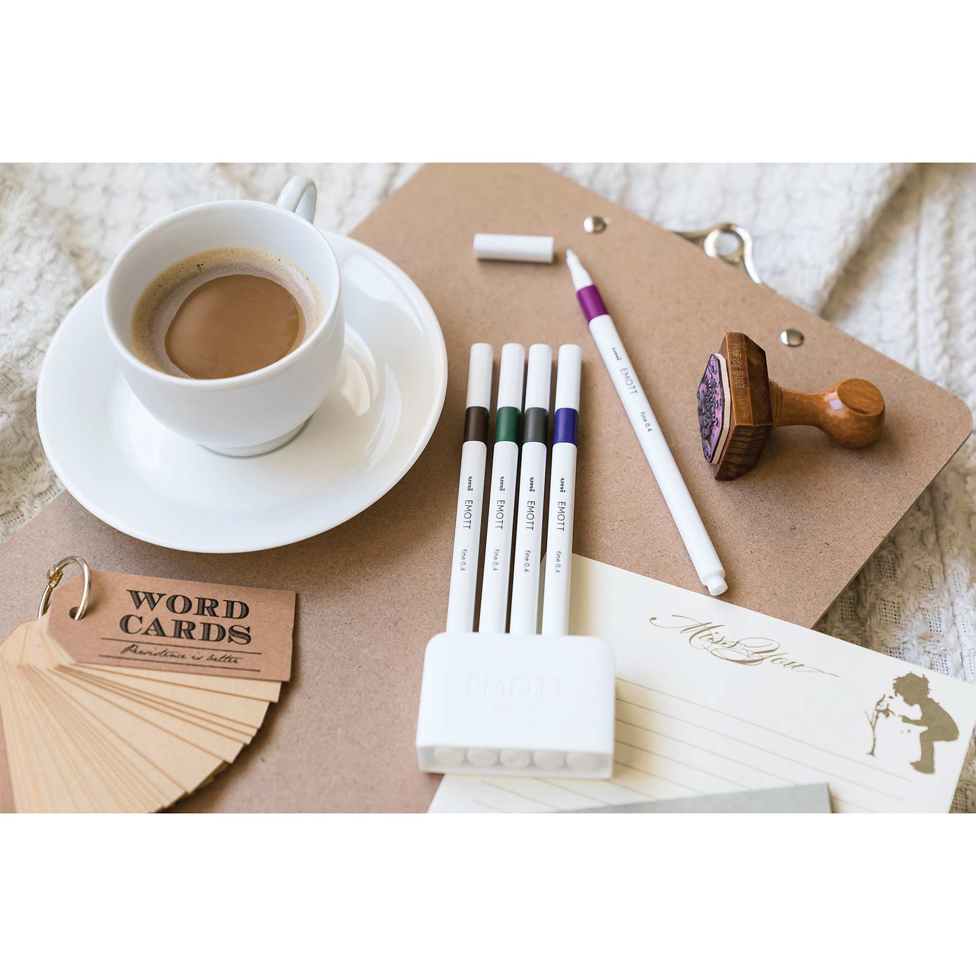 Uni Emott Fineliners - Set of 5, Vintage Colors (sitting on a table with one pen uncapped)