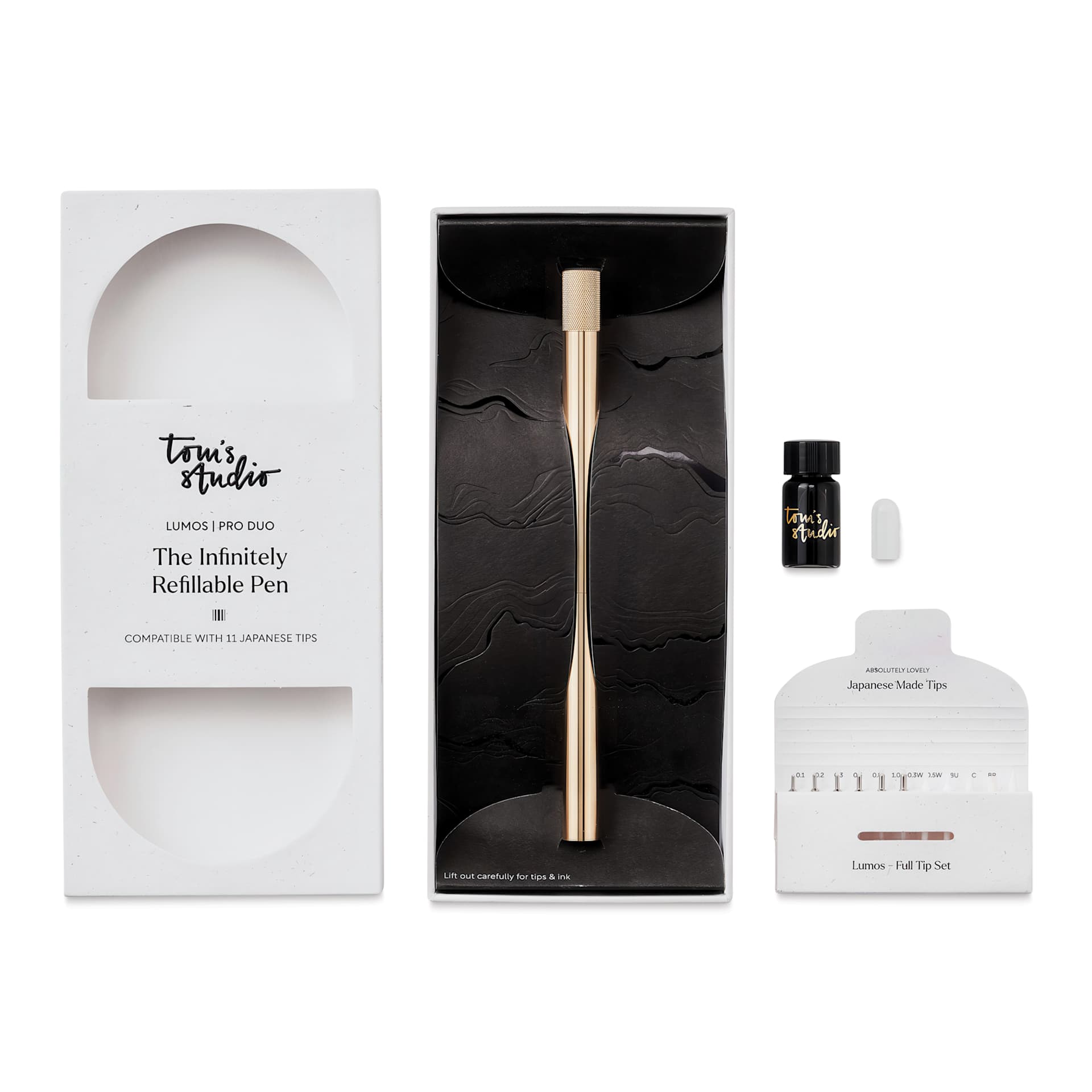 Tom's Studio Lumos Pro Refillable Dual Tip Pen Set - Brass, pen in packaging and contents laid out