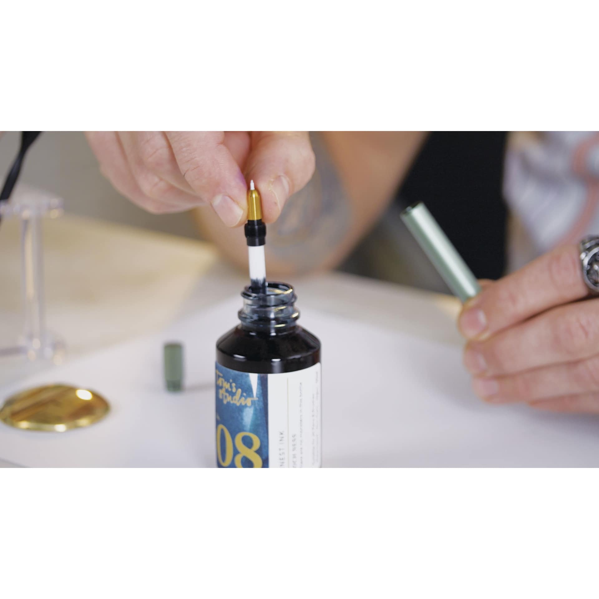 Tom's Studio Lumos Mini Refillable Pen - Sage, ink reservoir dipped in ink bottle (not included)
