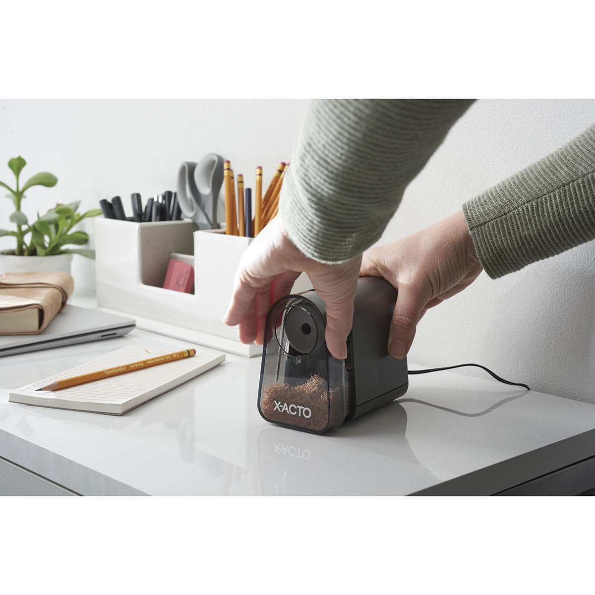 Mighty Mite Electric Pencil Sharpener with Pencil Saver - hands removing the shavings bin