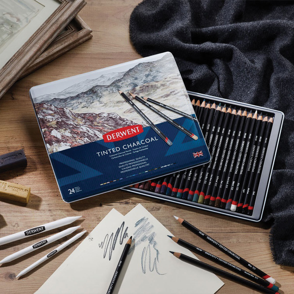 24 pc Derwent Tinted Charcoal Pencils Set open, and pencils being used on white paper.