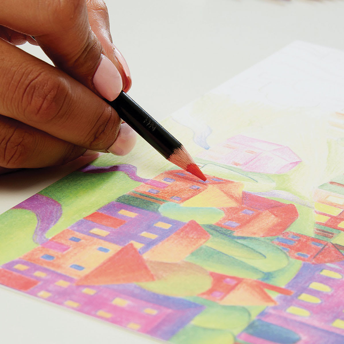 Derwent Academy Colored Pencil Set - Artist using pencils to color a town scene