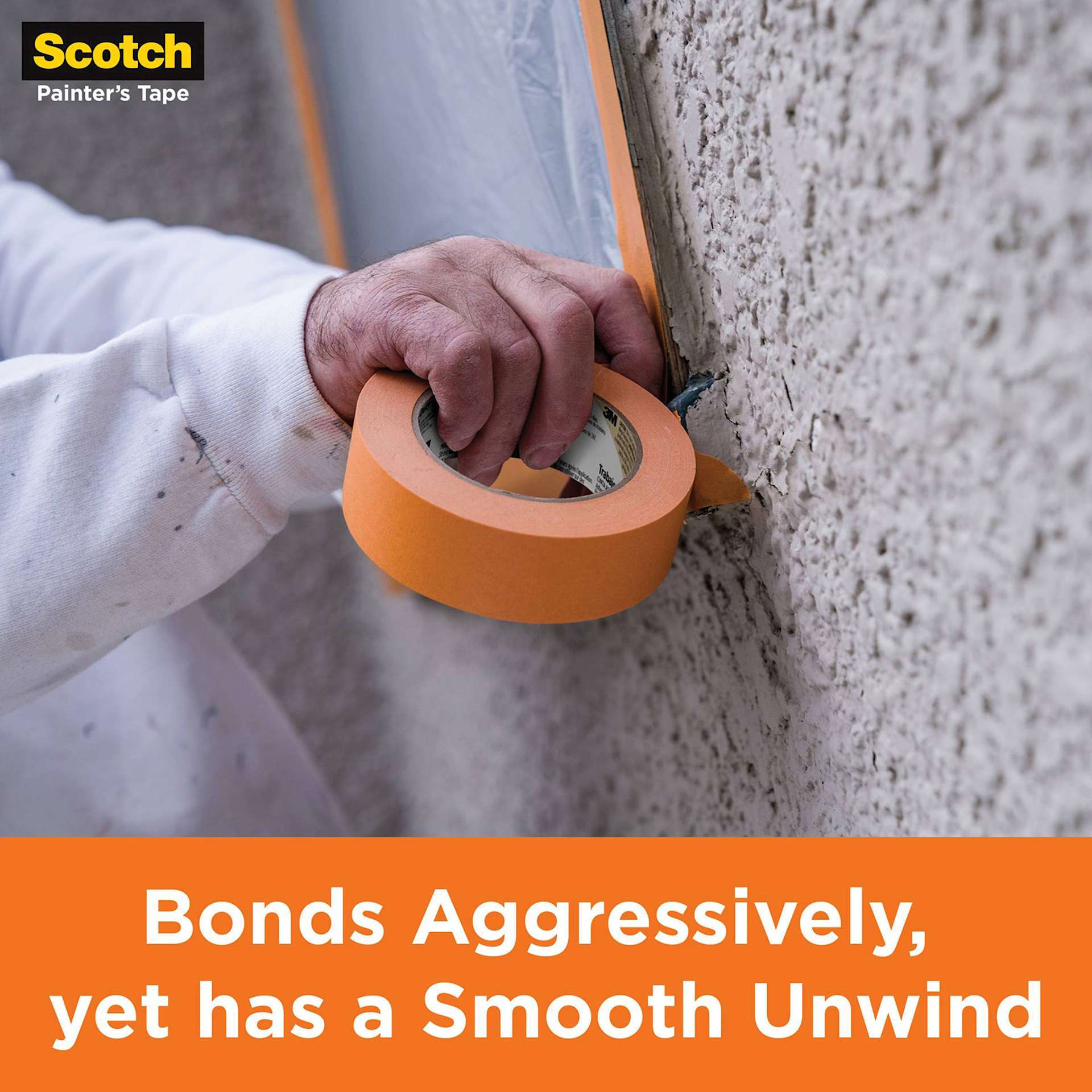 Scotch Heavy Duty Masking Tape. being applied to wall