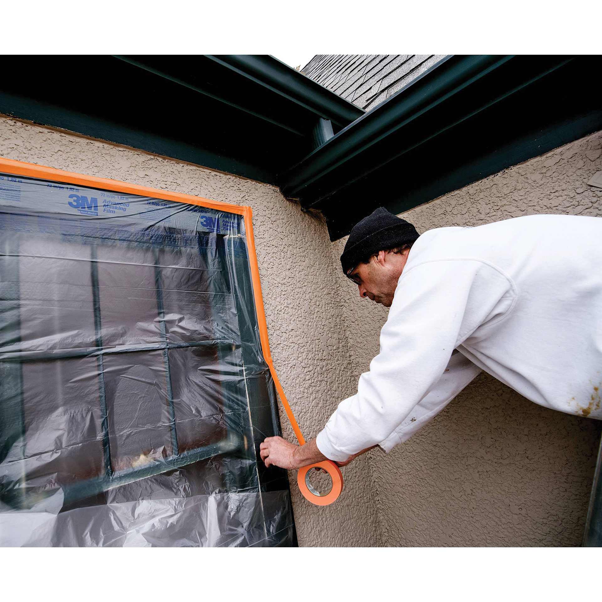 Scotch Heavy Duty Masking Tape, being applied to window
