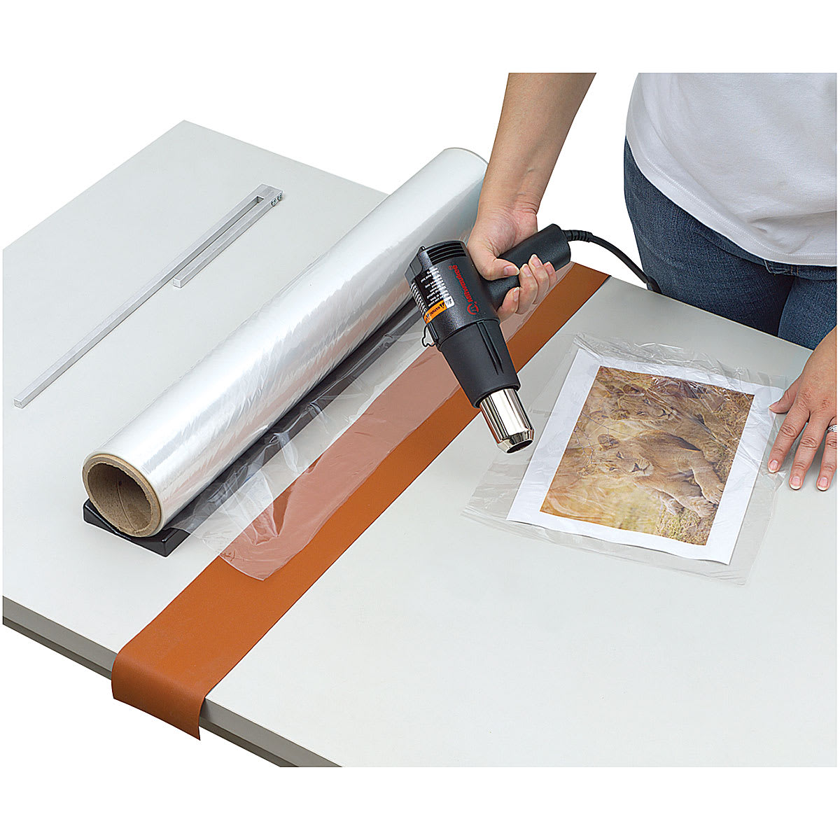 Mountex Shrink Wrapper Kit - Artist using heat gun from Kit