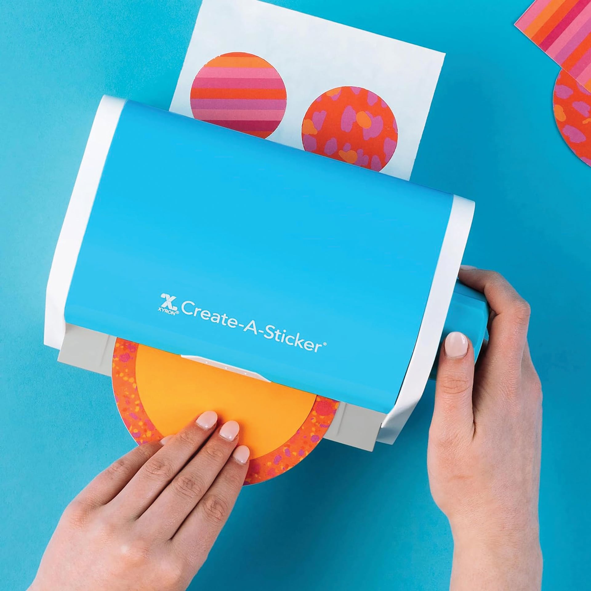 Xyron Create-A-Sticker Sticker Maker, sticker being removed from machine