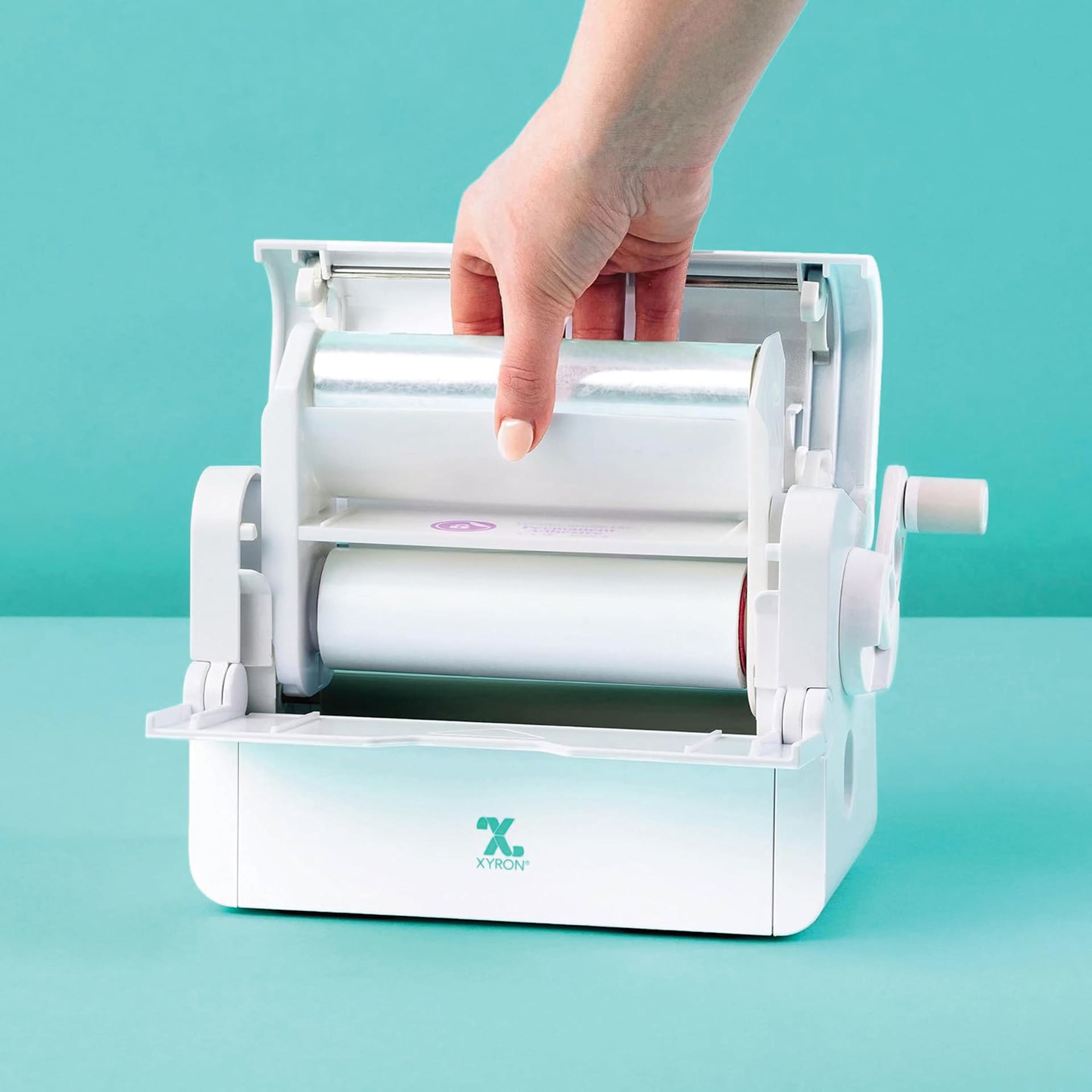 Xyron Creative Station Lite Laminated Adhesive Refill Cartridge being inserted