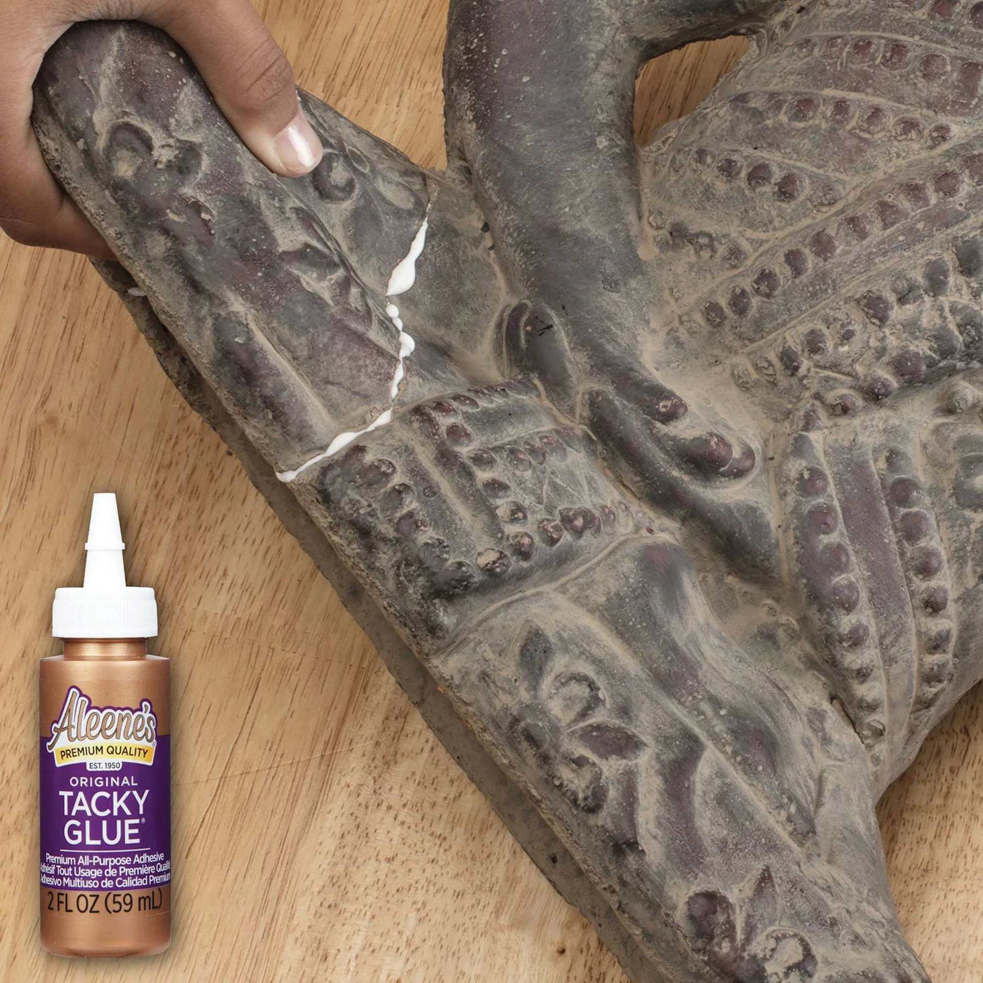 Aleene's Original Tacky Glue - 2 oz, Squeeze Bottle being used to repair sculpture