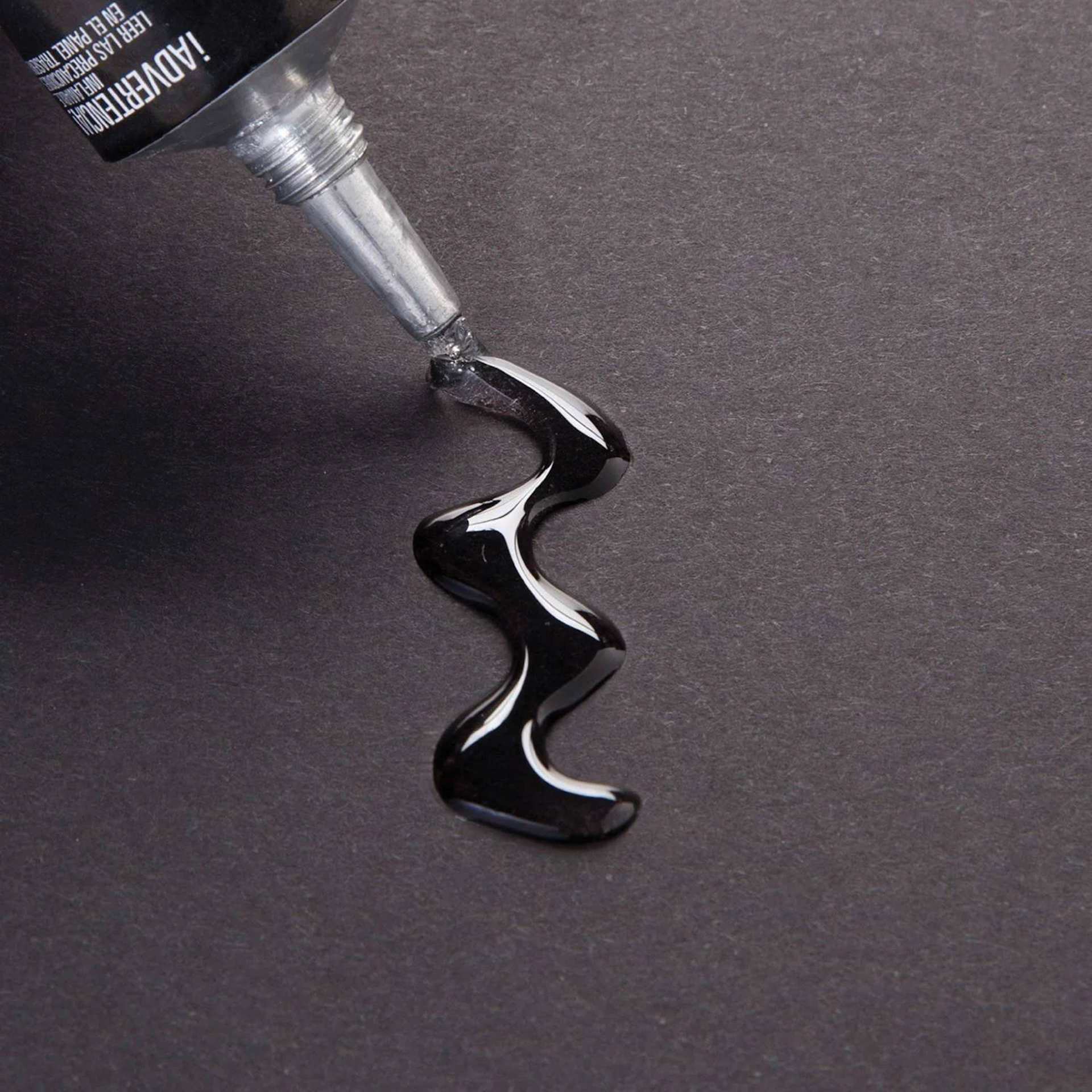 Aleene's The Ultimate Multi-Surface Adhesive - Pkg of 3, 0.1 oz each being applied