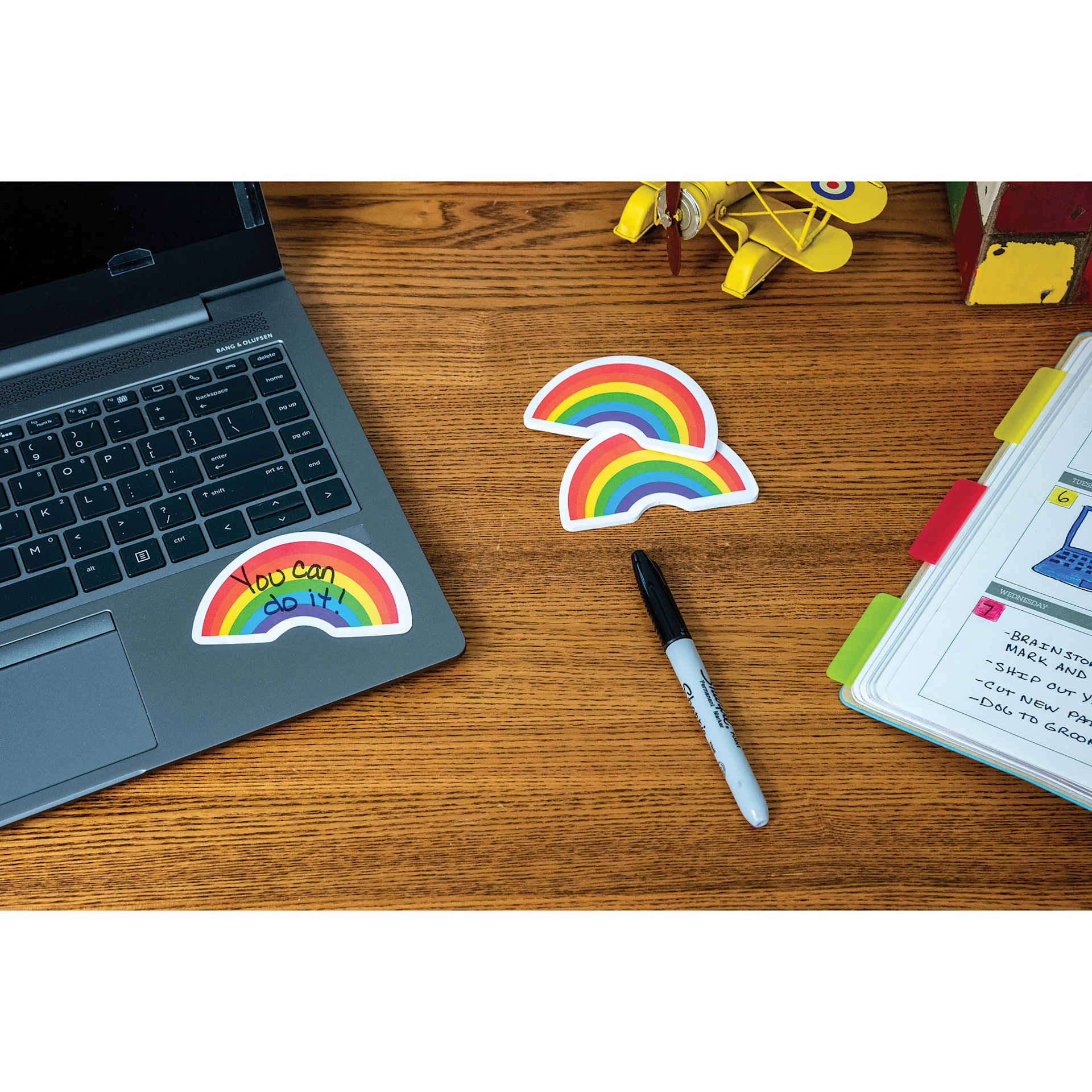 Post-it Rainbow Notes - written on and stuck on laptop's base panel