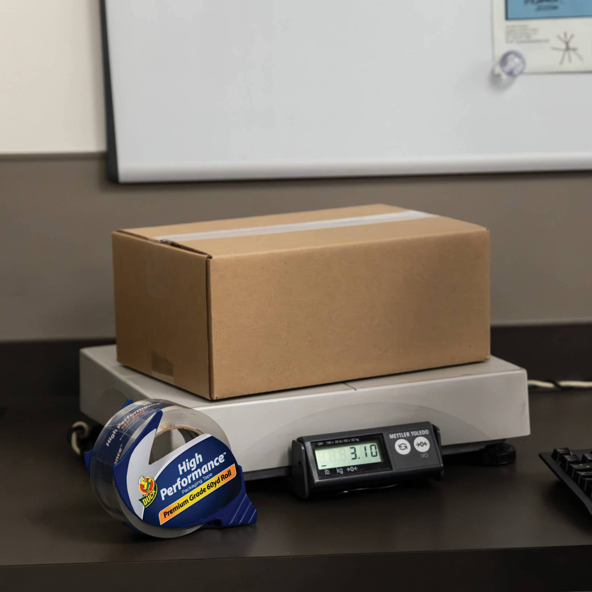 Duck HP260 High Performance Premium Packing Tape - 1.88" x 60 yds, with Dispenser - next to packages