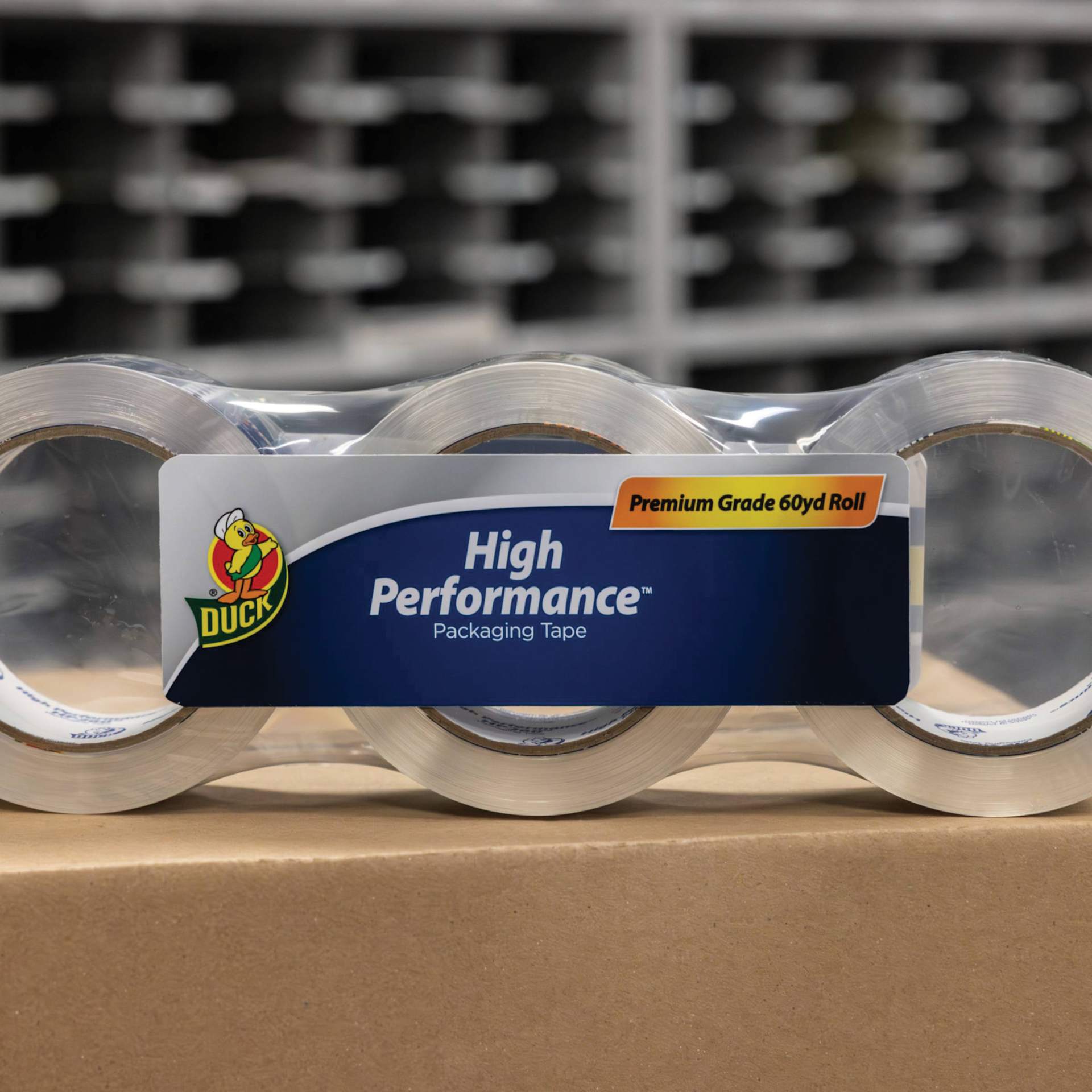 Duck HP260 High Performance Premium Packing Tape - 1.88" x 60 yds, Pkg of 3 - sitting on cardboard box