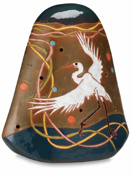 Fired and glazed pottery with a white bird