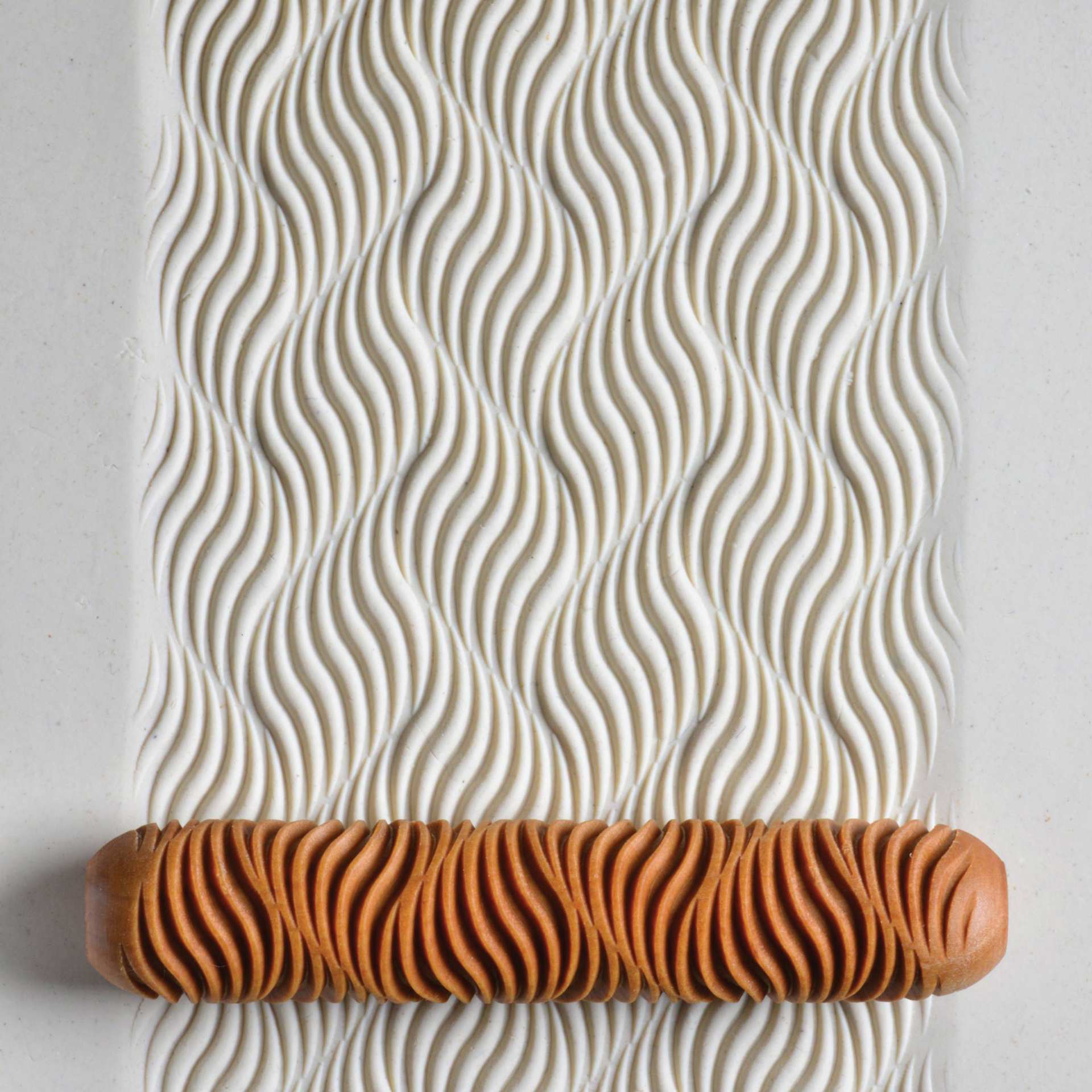 MKM Pottery Tools Big Hand Roller - Wave Flow applied to clay