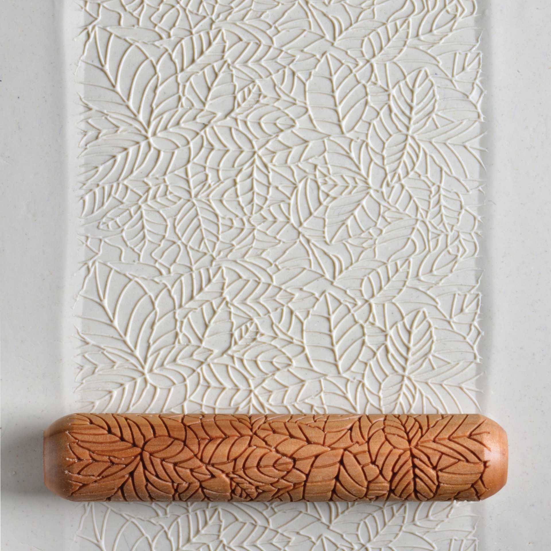 MKM Pottery Tools Big Hand Roller - Bed of Leaves applied to clay