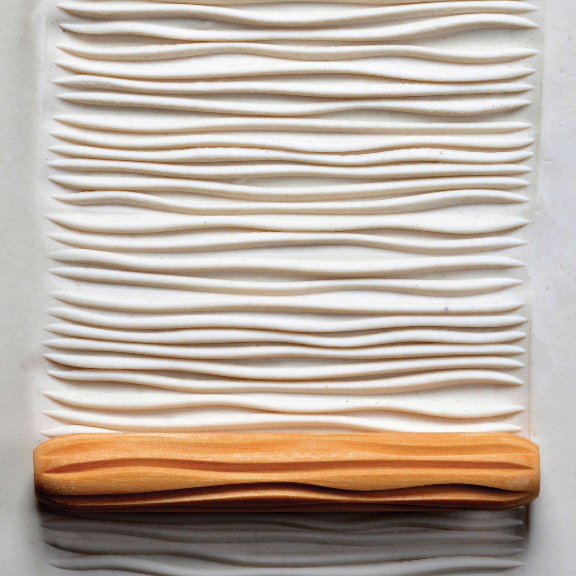 MKM Pottery Tools Hand Roller - Wavy Horizontal Lines applied to clay