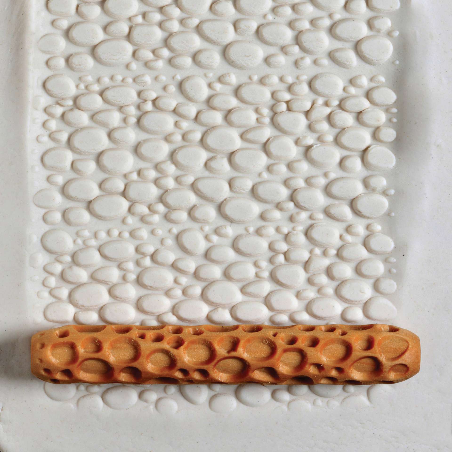 MKM Pottery Tools Hand Roller - Cobbles applied to clay